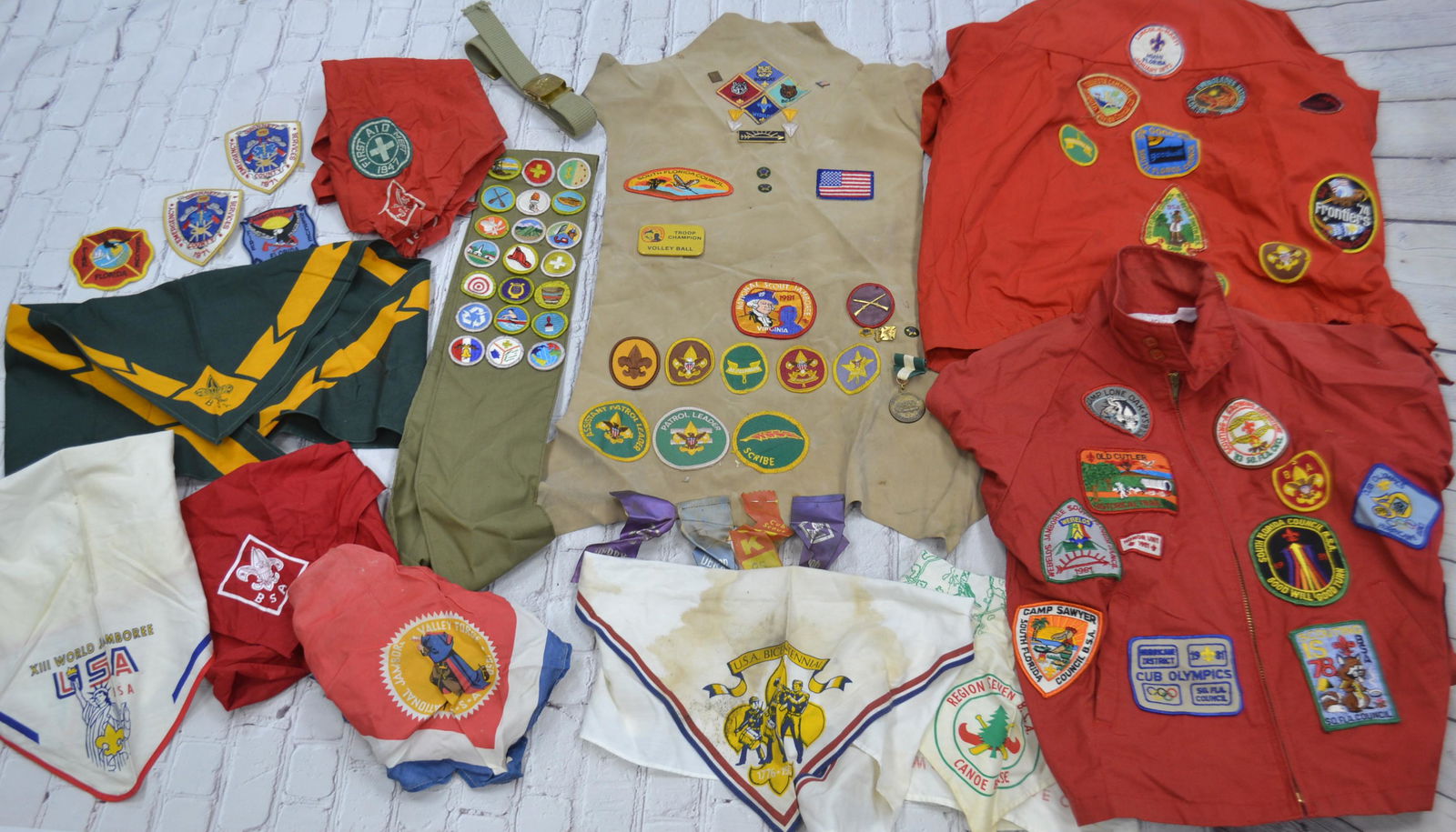 Vintage Boy Scout Patches and Collectibles: Vintage Boy Scout Patches and collectibles including 2 boy scout jacket with patches, sash with merit badges, various boy scout bandanas and related items. The 2 red jackets are boys size 18/one label