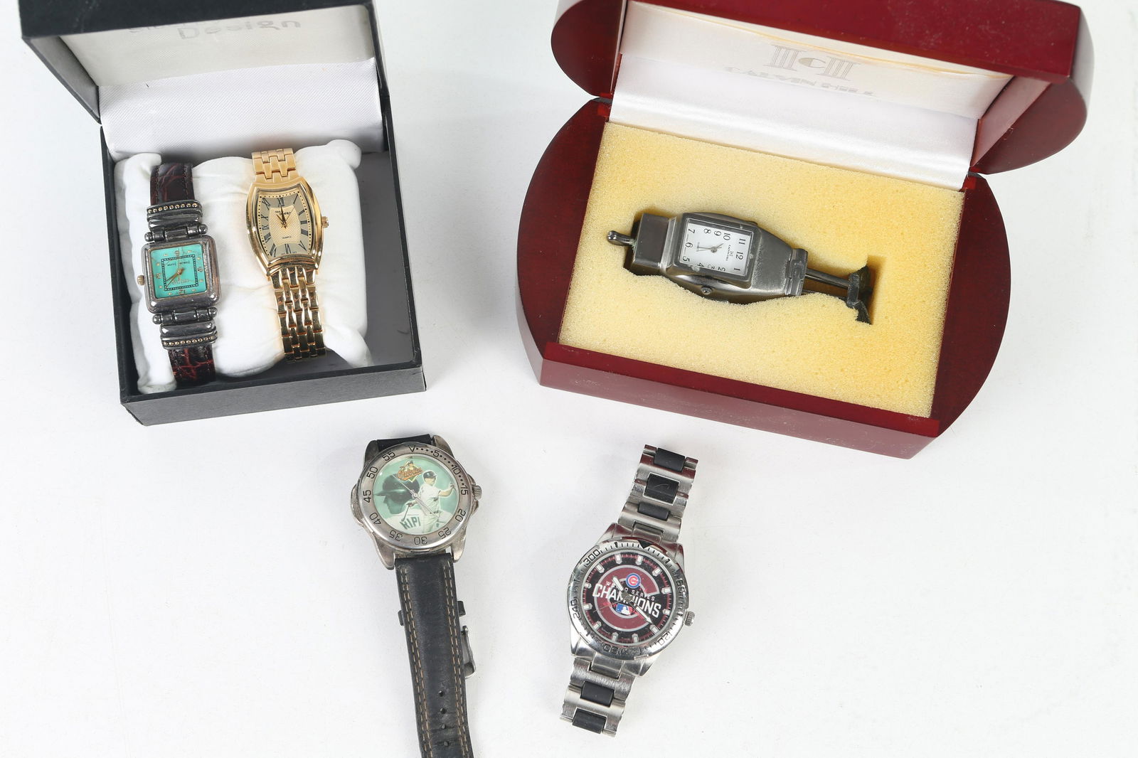 Sports and Other Wristwatches: Lot includes a Game Time Cubs World Series Champion wristwatch (currently running), Cal Ripken wristwatch, Calvin Klein golf bag pendant watch in case, Steel Design ladies watch (marked Swiss parts),