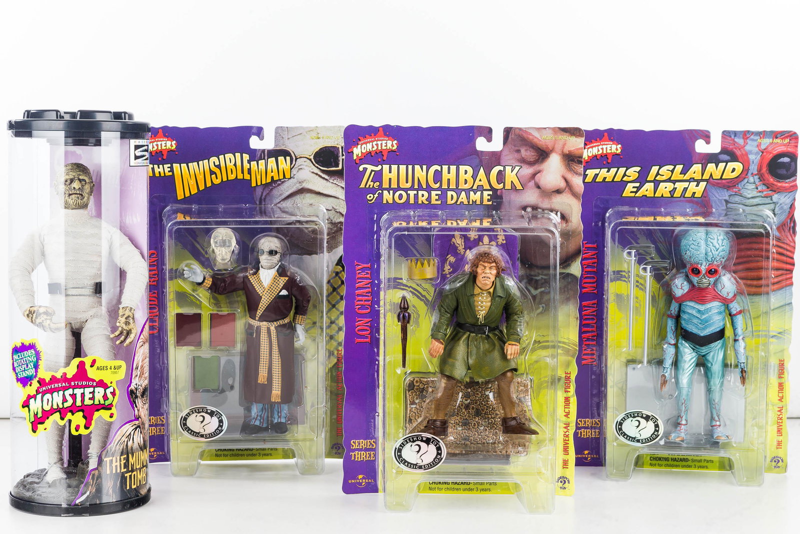 Universal Studios Monster Figures (4) NIB: Universal Studios The Mummy's Tomb with rotating display stand by Hasbro Signature Series c1999 item#70957 (also in shipping box) and 3 Series 3 Monsters - Lon Chaney, Claude Rains, and Metaluna Mutan