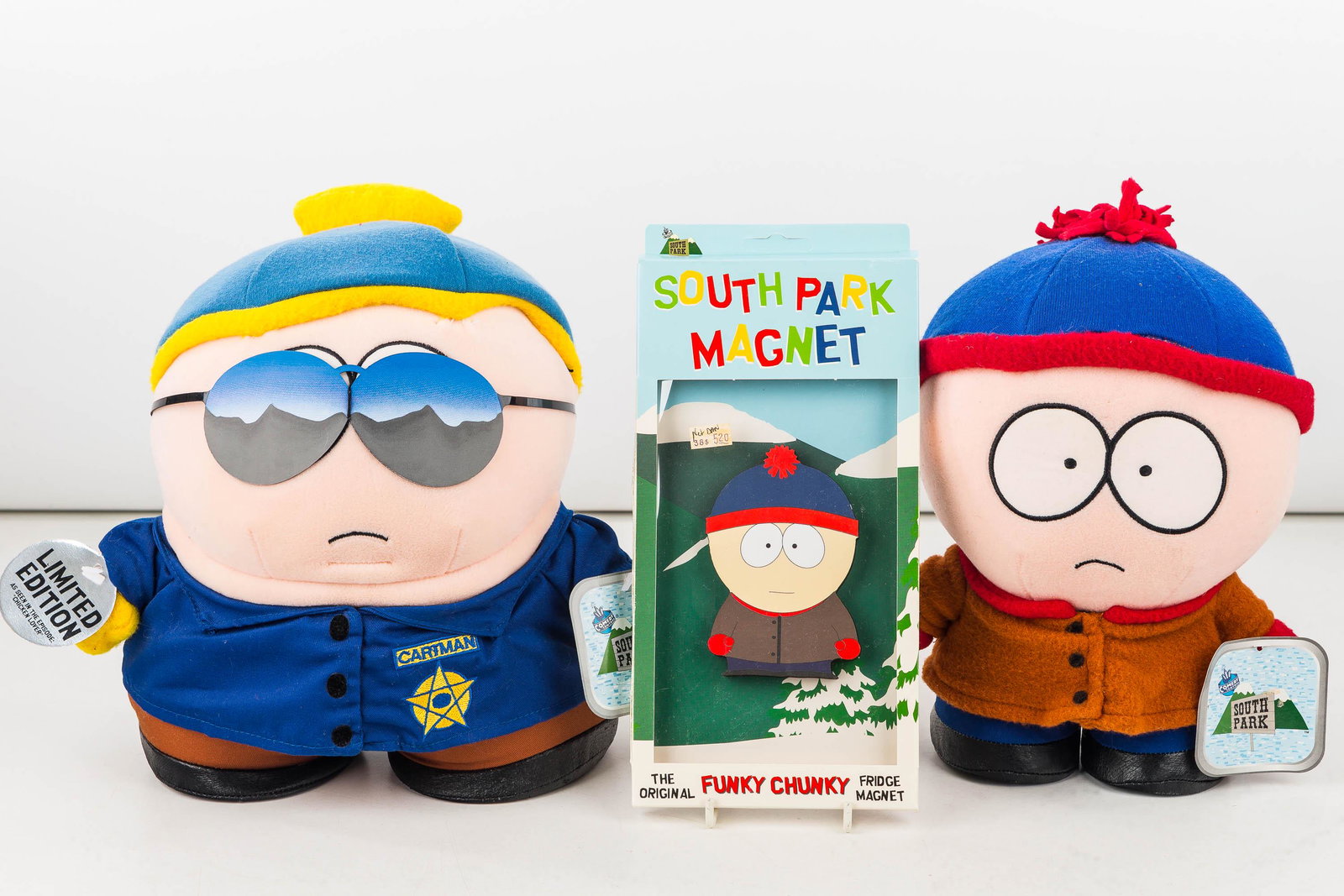 South Park Stan and Cartman Dolls and Magnet: Stan and Limited Edition Stan with sunglasses and badge from the Episode Chicken Lover, both c1998 plush dolls approx 10" tall made by Fun4All Corp. also includes a Stan Fridge Magnet NIB.c1998