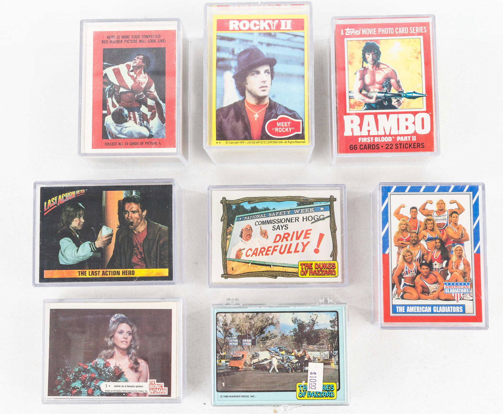Collectors Cards / Rocky, Rambo, More: Eight card sets including Rocky II, Rocky IV, Rambo First Blood, The Bionic Woman, Last Action Hero, 2 from The Dukes of Hazard and 1 American Gladiator c1991. Card sets not checked for completeness.