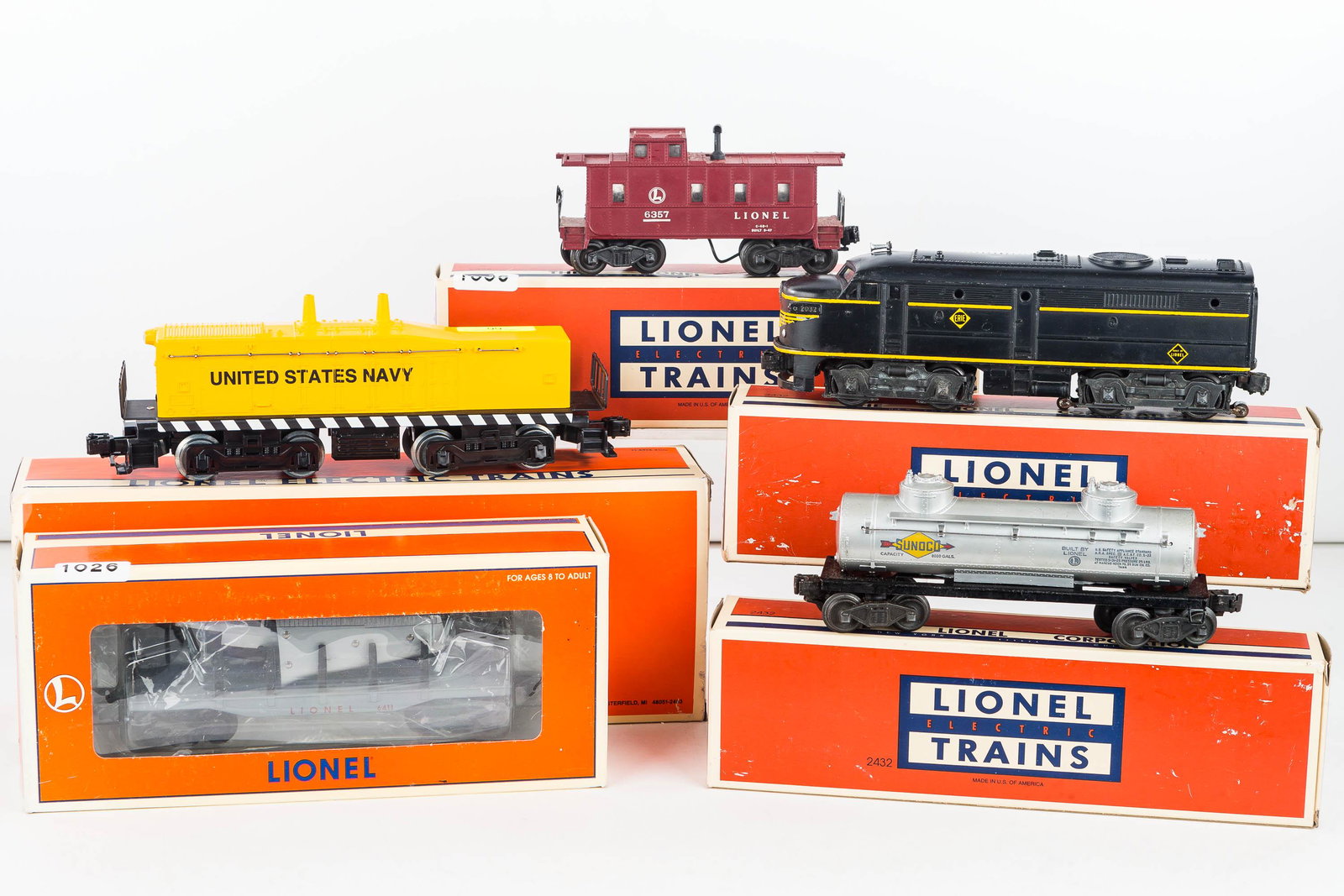 Lionel "O" Scale Train Cars In Box: Including tank car #6465, Caboose # 6357, Dummy Unit #2032, Flatcar with airplane #6-16969 and US Navy Calf Unit # 6-18938.