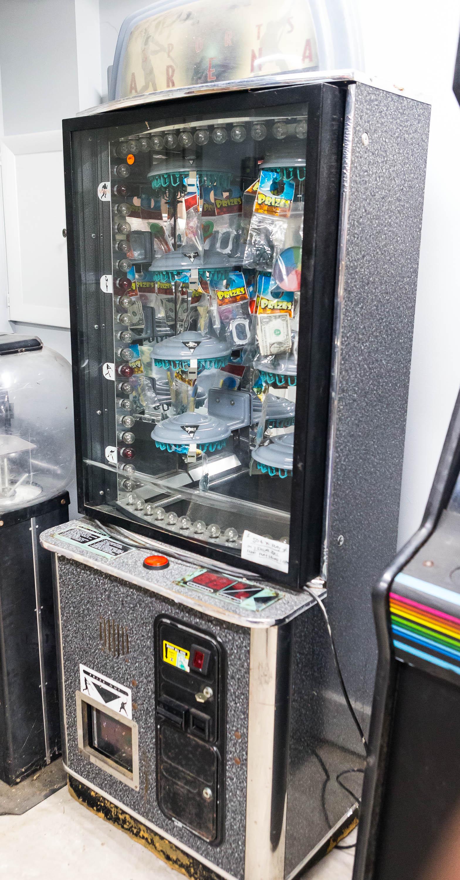 "Sports Arena" Vending Game Full Size: Sports Arena arcade game. This machine is in working condition and was in operation last season. Players insert coins and press the button to stop the moving lights in the hopes of landing on a red li