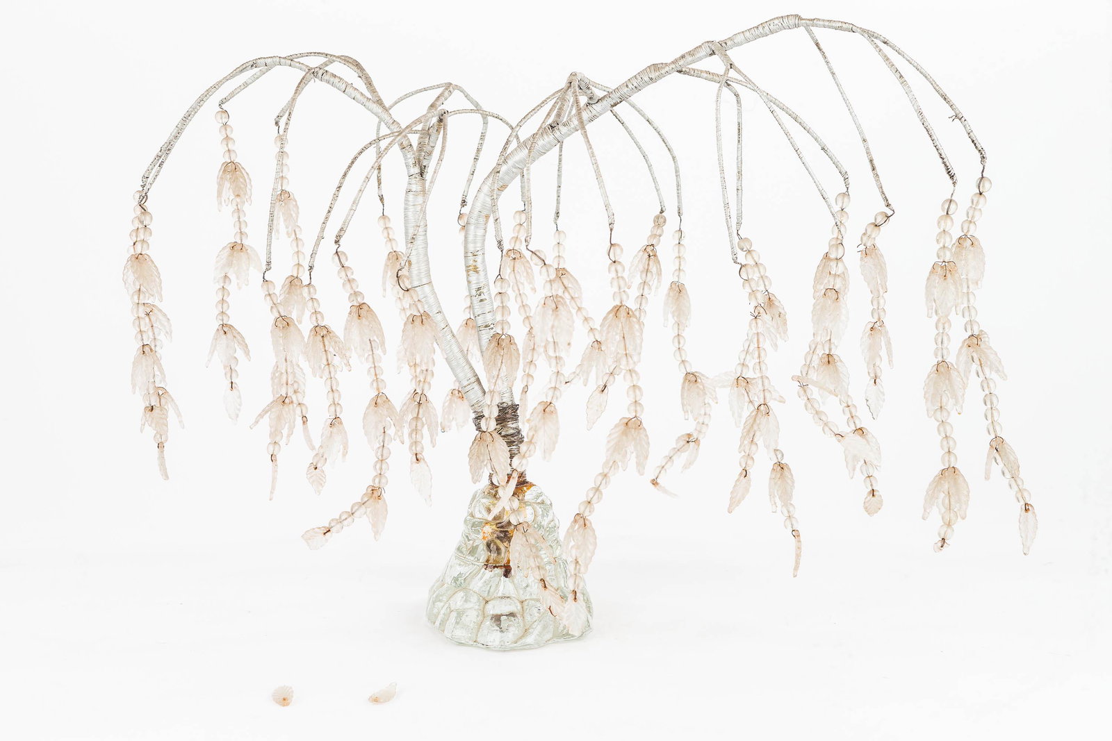 Glass Mourning Tree: Mourning tree sits on a molded glass base. Unsure what is wrapped around the branches, could be wire or string, and it appears to be painted silver. The tree is missing a few leaves and some are broke