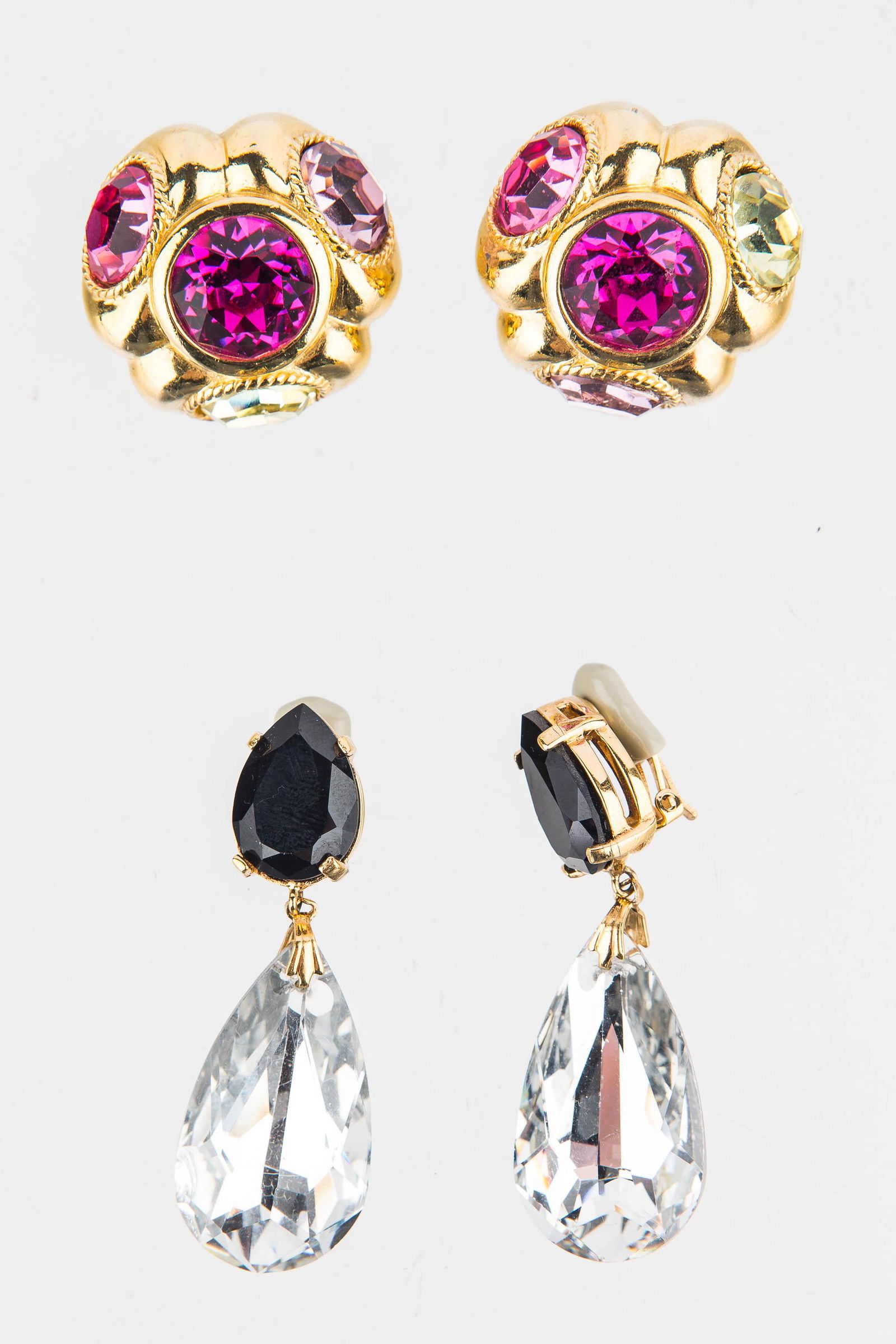 Ciner Vintage Designer Earrings: Large hot pink and green stone gold tone clip earrings signed Ciner and large clear drop clips signed Ciner.