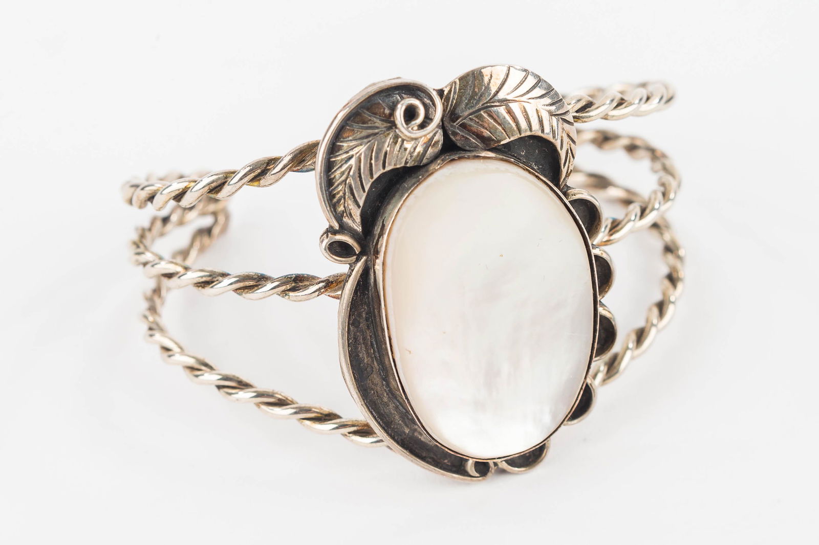 Native Sterling Ladies Cuff with Inlay: Stone inlay is likely mother of pearl but may be abalone and is a 3 banded cuff with leaf decoration. 1.25 OZT