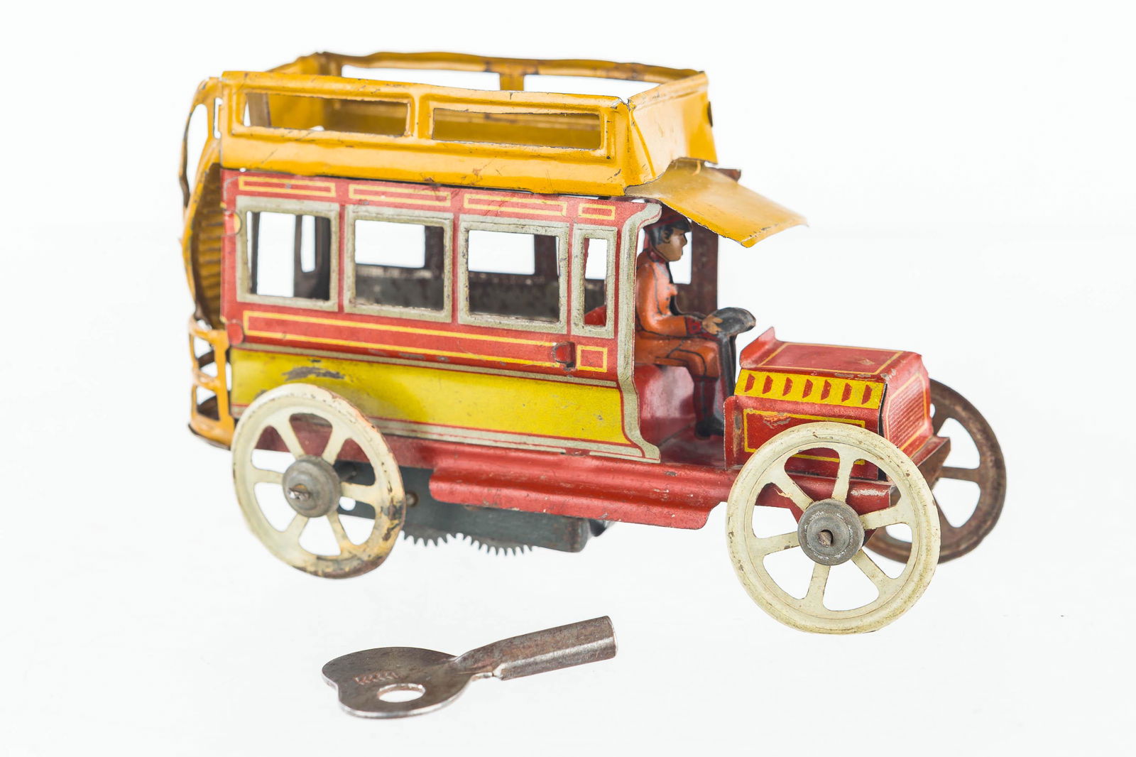 1915 Distiller Tin Litho Wind Up: Toy measures approx. 2 3/4' x 4 1/4", it has good graphics and is functional. Not marked.