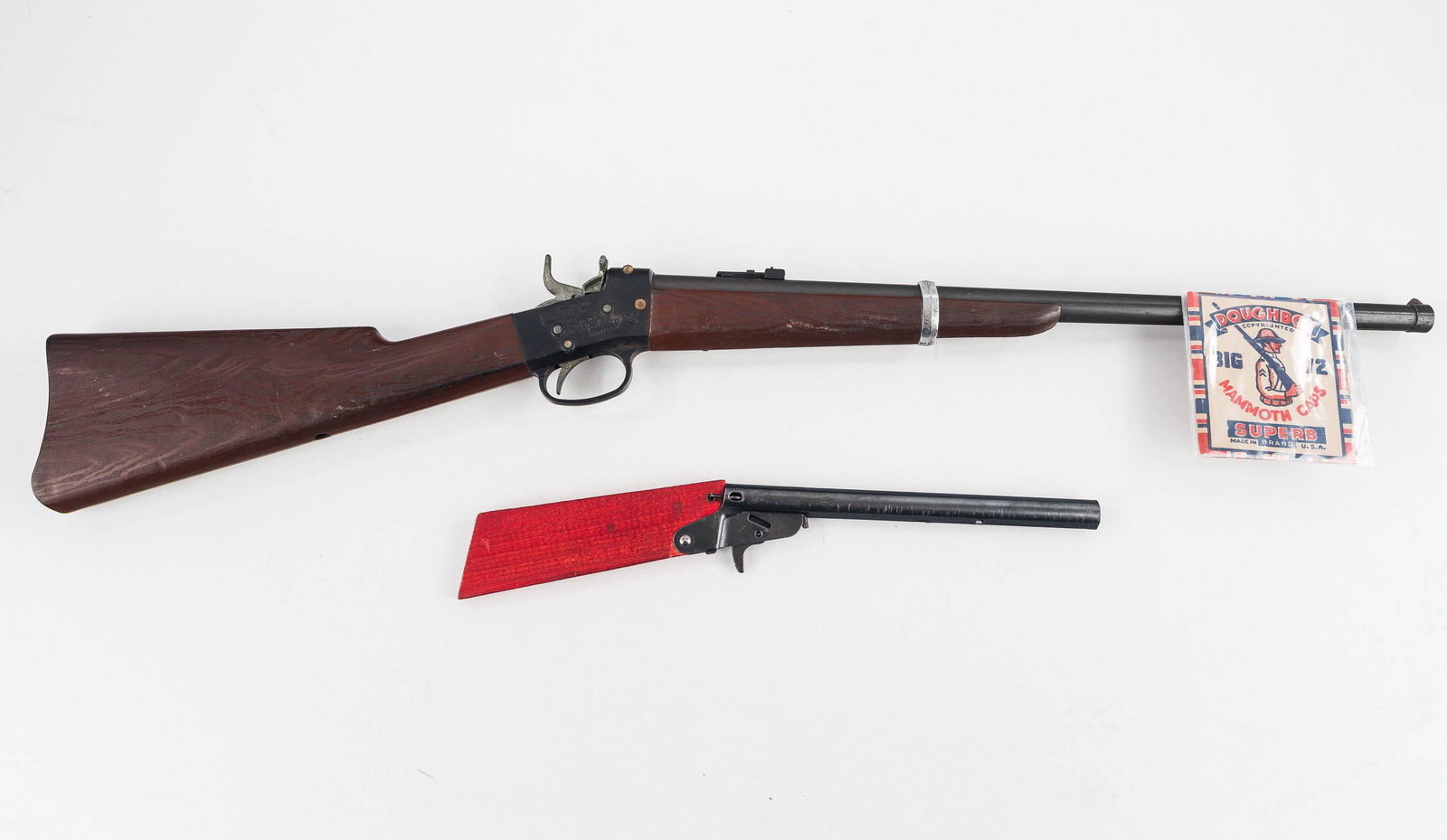 Shootin' Shell Pog Gun and Another: A metal and plastic toy cap gun measuring approx. 29.5 "L Doughboy Superb, functional. Produced by Mattel. Lot also includes small metal and wood gun, also functional.