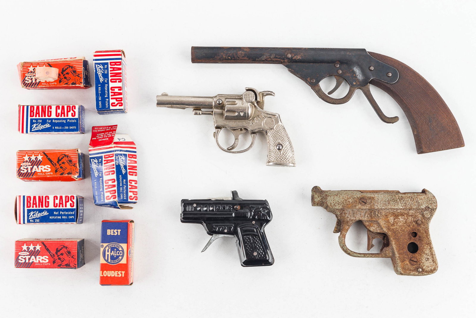 Vintage Cap Gun Collection: Including a Victor miniature pop gun, working; a Kenton Extra cap pistol, working; a Star tin cap gun, working; a remnant cap gun and caps.