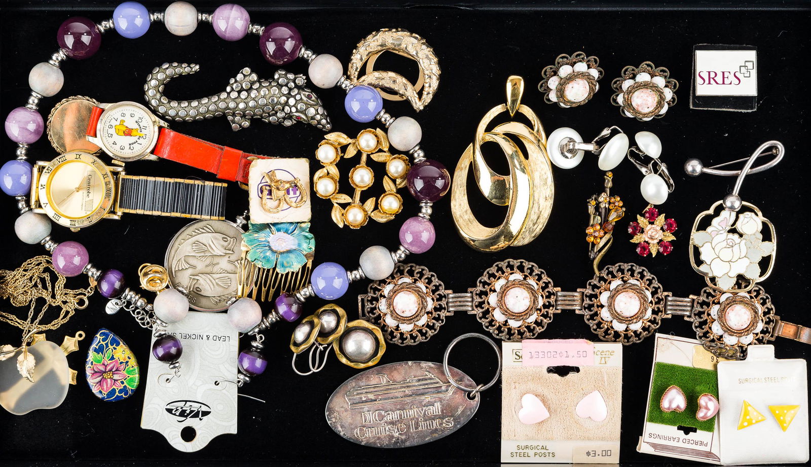 Watches and Mixed Costume Jewelry: Lot includes a Winnie-the-Pooh watch, Swiss-made, goldtone Proton wristwatch, large goldtone Trifari pendant, alligator brooch, and other costume jewelry.