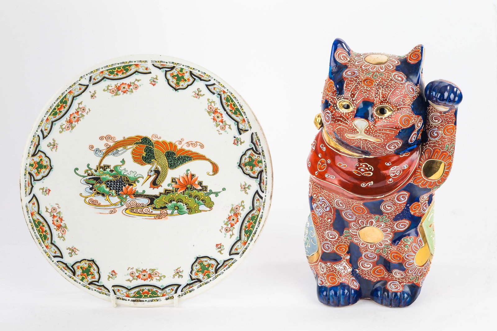 Satsuma Lucky Cat and a Tray: Cat measures approx. 10.5" H and is heavily decorated. It has remnants of a chop mark on bottom and is contemporary. Lot also includes a decorative trivet with Phoenix decoration.