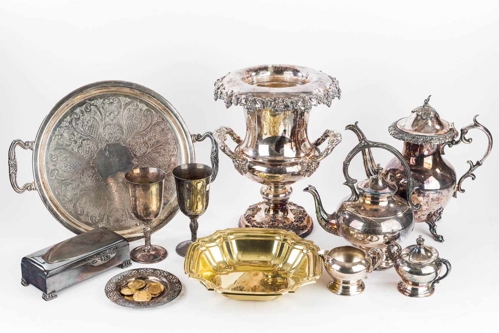Quality Silver Plate Grouping: Lot includes a wine bucket measuring approx. 13" H, (2) teapots, a tray, and other silver plate.