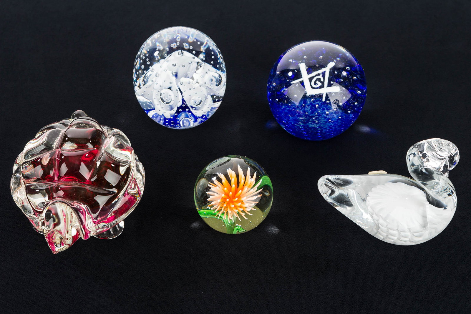 Masonic and Other Paperweights: Lot includes paperweight with blue interior and white Masonic symbol; paperweight with calla lilly and controlled bubble interior marked "Gibson 1995" on base; a swan paperweight with paper label read