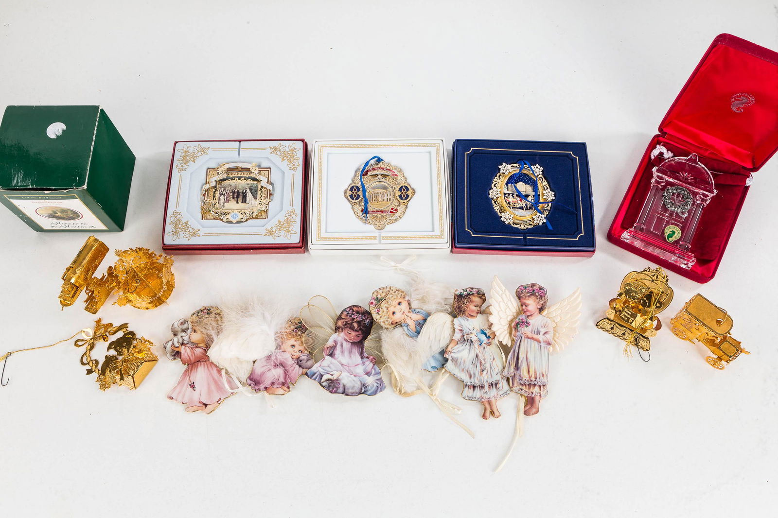 Franklin Mint and Other Christmas Ornaments: (5) gold tone cutout Franklin Mint ornaments, Waterford and Bradford exchange angels, a Thomas Kinkade ornament, and a 2006 White House ornament.
