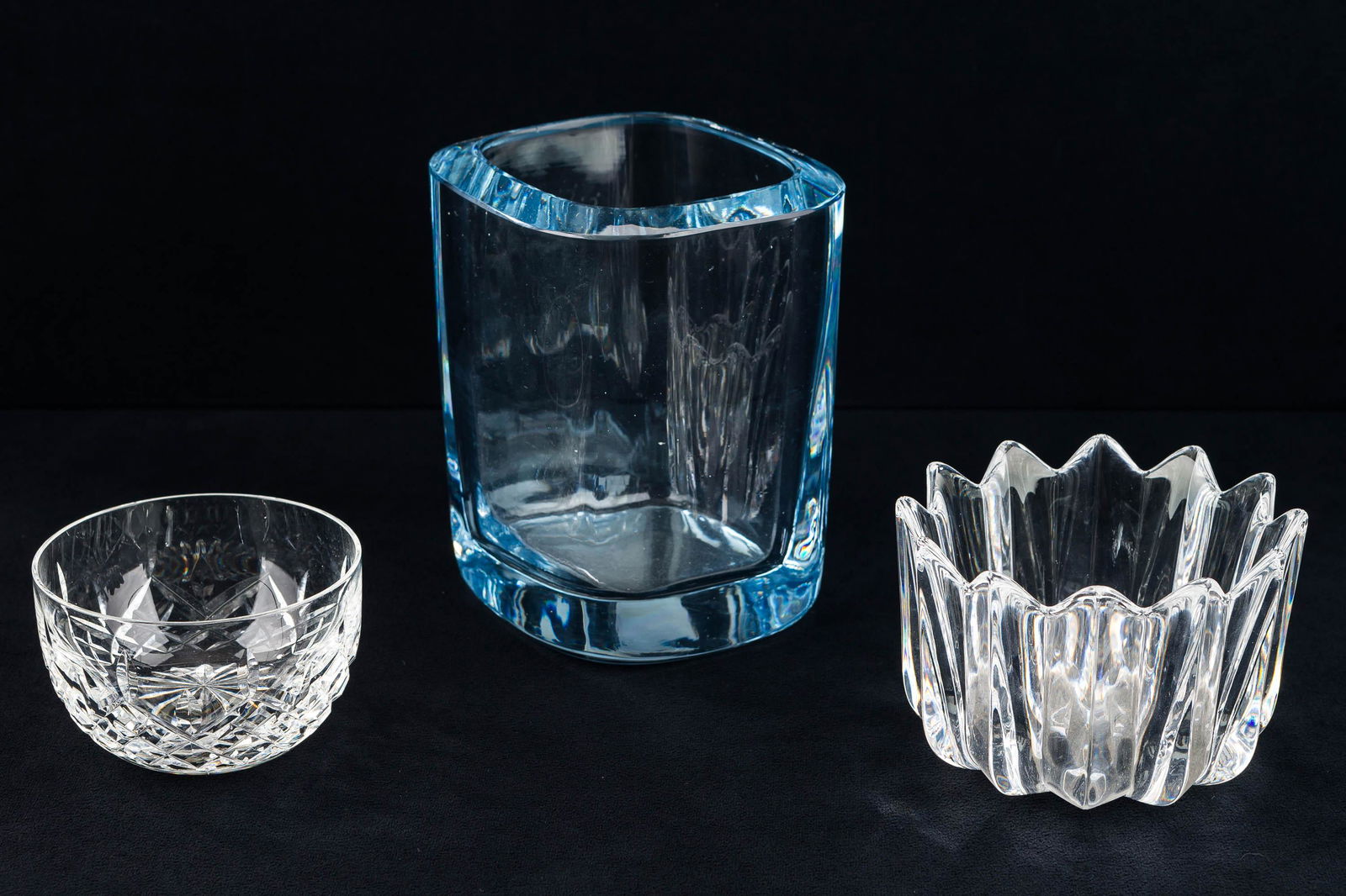 Orrefors,Strombergshyttan & Waterford Crystal: There are (3) crystal items including a Strombergshyttan glass vase, blue tinted, signed, measuring approx 6.75" H x 4.75" W, along with a shallow bowl marked "Waterford" and a signed Orrefors crown h