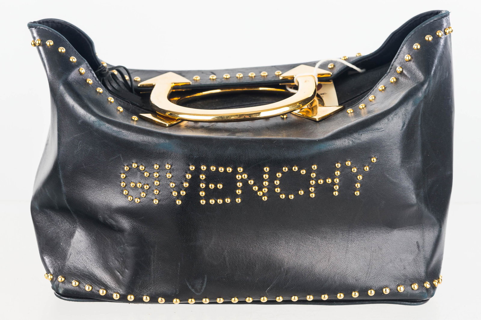 Designer Givenchy Handbag: Vintage original handbag signed gold metal label Givenchy Paris Made in France, black kid-skin leather, gold stud details spell out Givenchy; with arrow design heavy gold tone handles line with textur