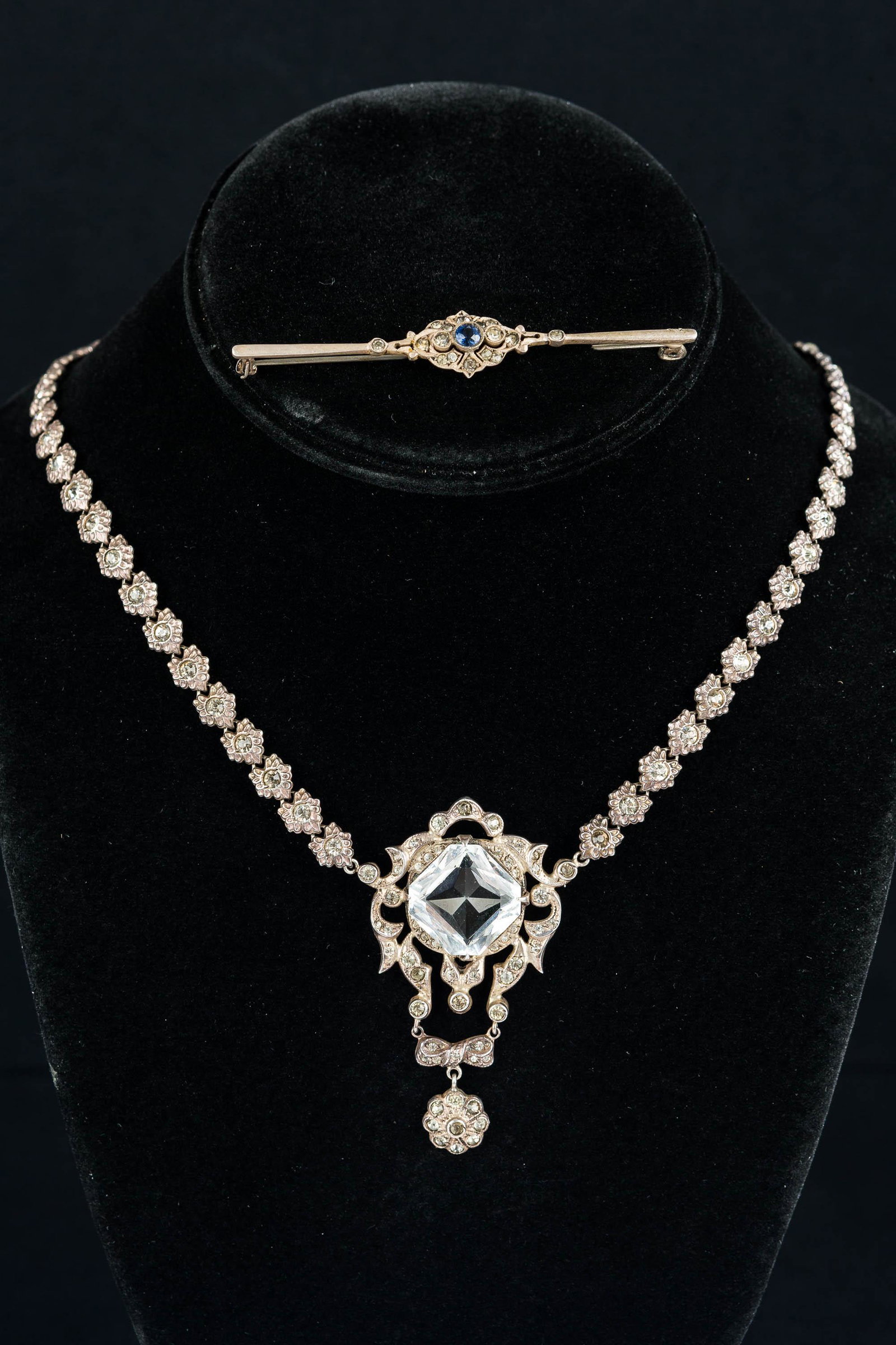 Antique Sterling Crystal Necklace: Exquisite, signed Edwardian sterling silver and crystal necklace with floral detail encircling entire necklace, with central intricate square cut pendant and floral drop detail. Also "Germany" sterlin