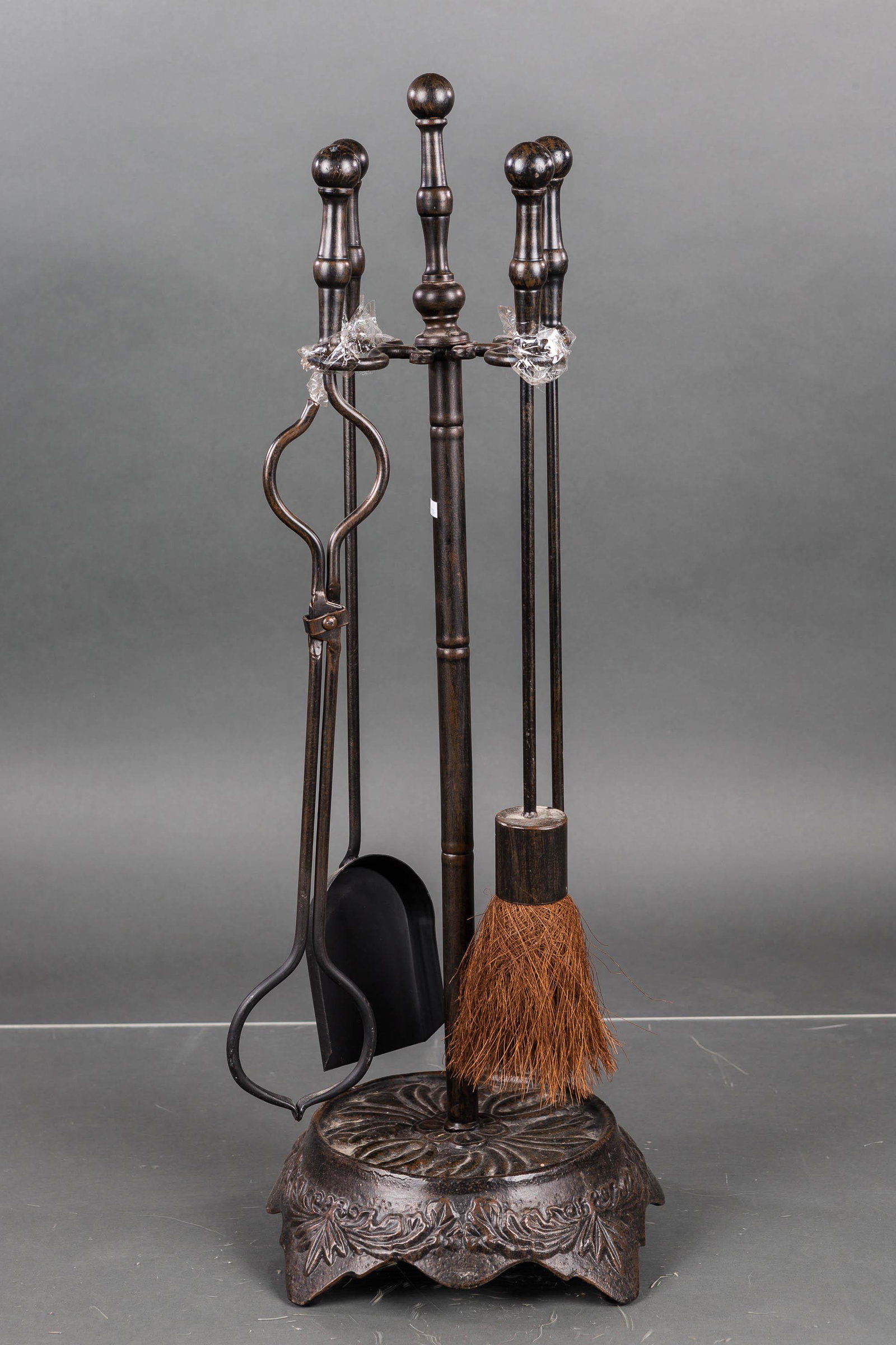 Cast Iron Fireplace Set: The set has a leaf pattern base and includes (4) fireplace tools.