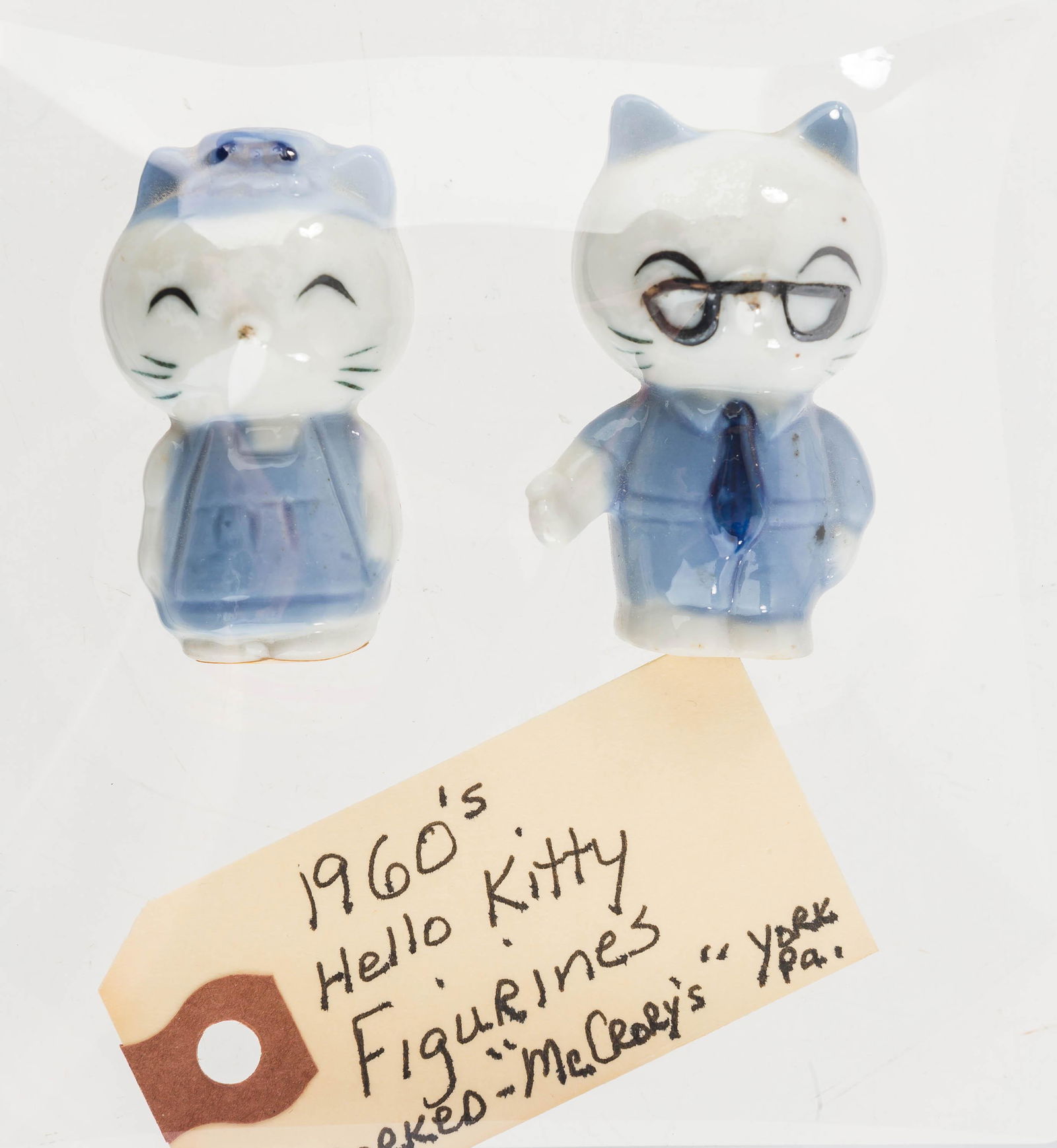 1960s "Hello Kitty" Figures: These hand-painted ceramic figures retain paper label reading "Gifts from around the world, Handcrafted in Japan, Former McCrory Corp. York, PA 17402". The larger measures approx. 2" H.