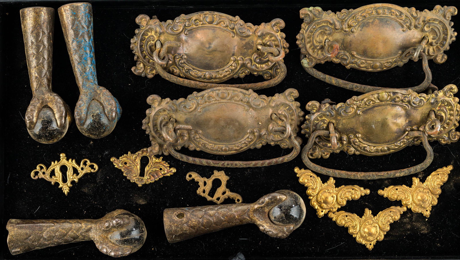 Dresser Bales and Claw Feet: There is a matched set of (4) pressed brass bales (handles, pulls), a set of (4) feet with glass balls, and various escutcheons.