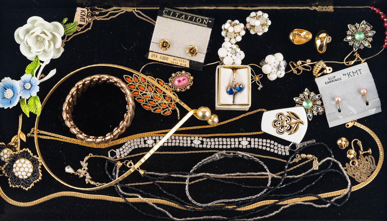 10K Gold Ring & Costume Jewelry: This lost includes a 10k ladies ring with blue stones size 6.5, a pair of Monet clip earrings, enamel and other costume jewelry.