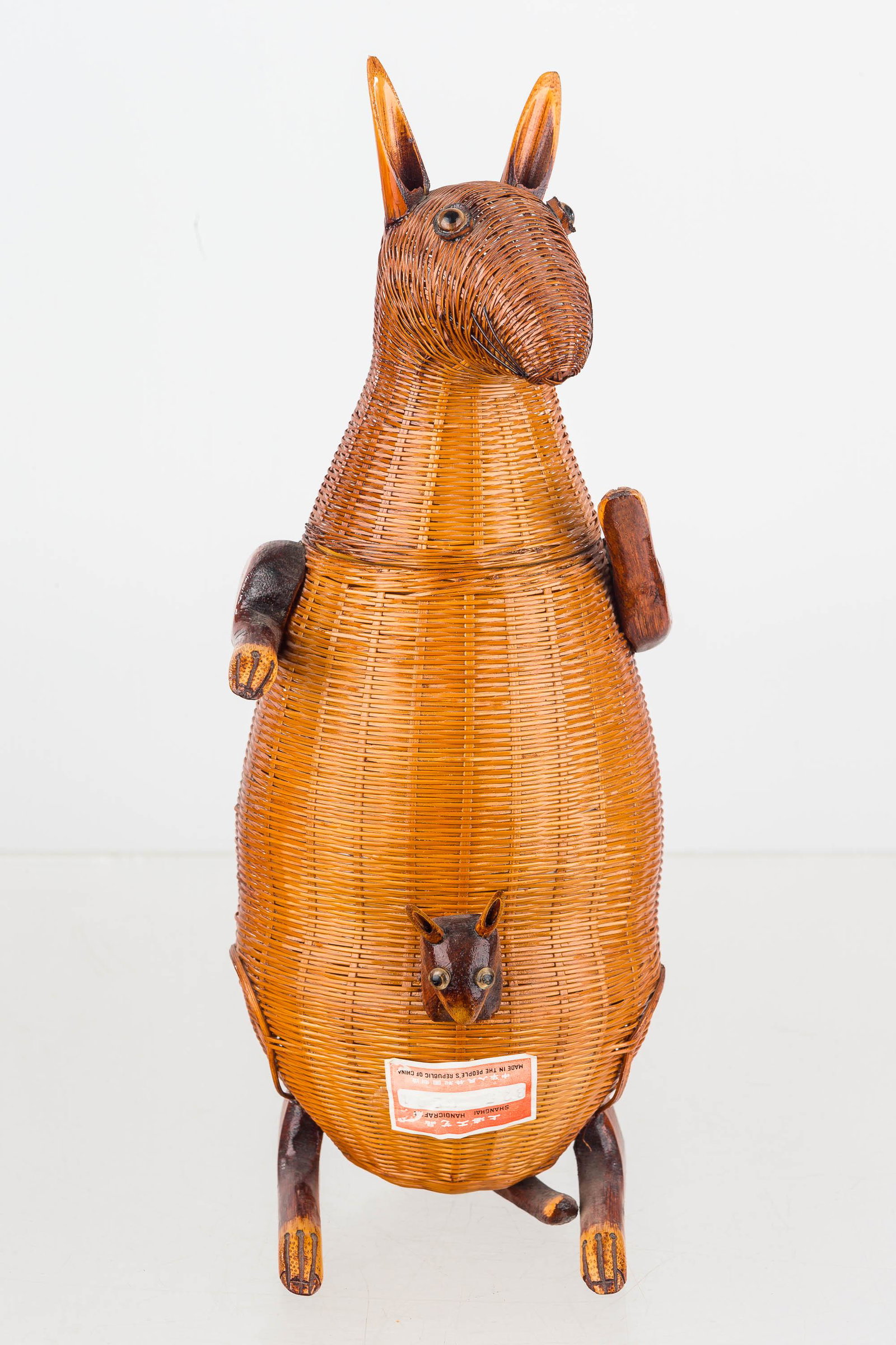 Bamboo Wicker Shanghai Handicrafts Kangaroo W/Joey: Vintage, made in People's Republic of China, it is a hollow wicker container. The kangaroo and joey have applied plastic eyes and it measures approx. 12" H. Item retains paper label.
