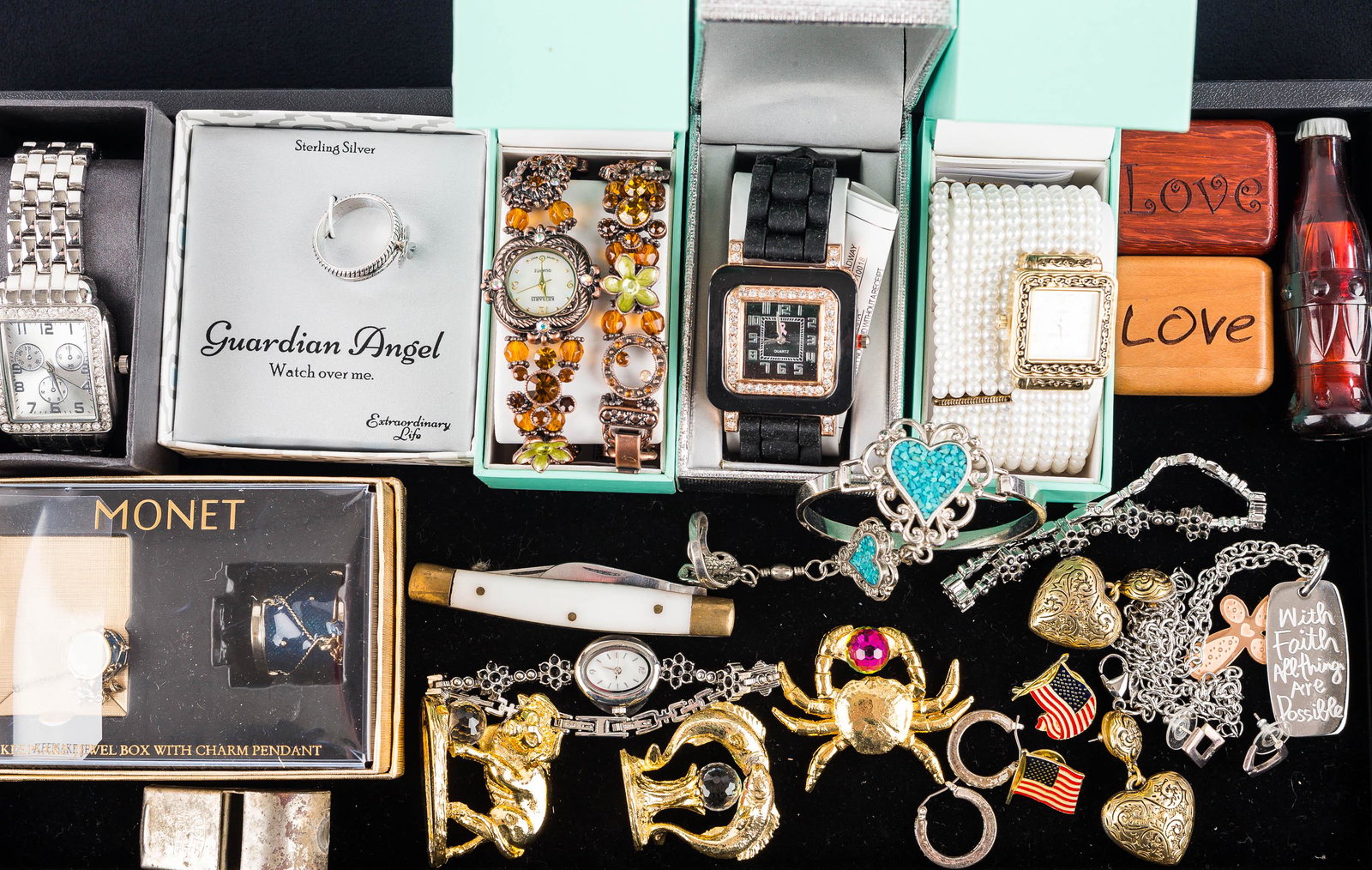 Monet Jewelry and Watches: Monet drum, pendant, and charm set; a sterling guardian angel ring; goldtone zodiac figures with crystals; designer watches, including Kessaris and others.