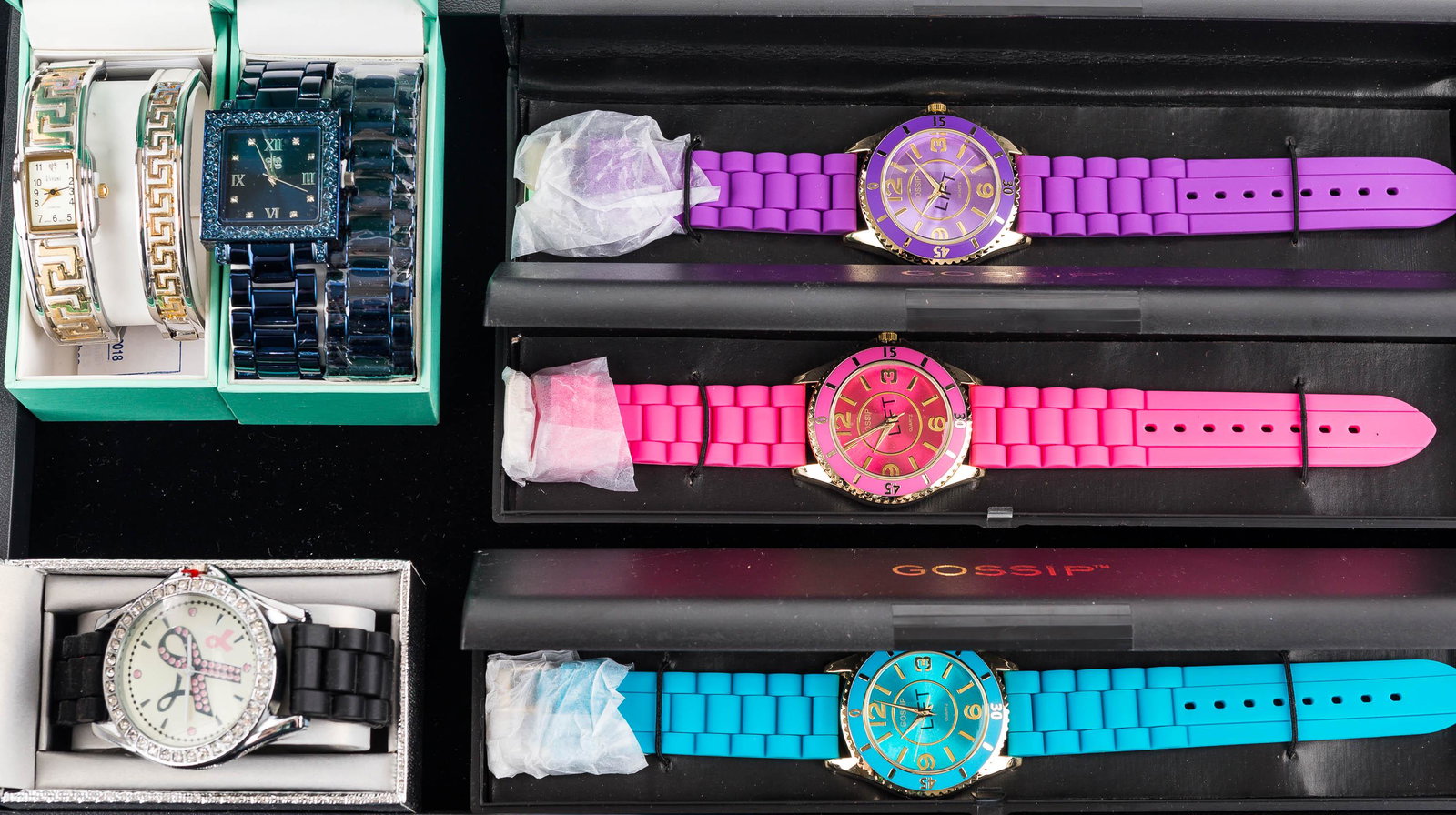 Ladies' Watches NIP: There are (3) ladies' Gossip watches NIP, ladies' Vivani watch set with (2) Greek key bands, ladies' blue face and band watch set, and a ladies' breast cancer watch in box.