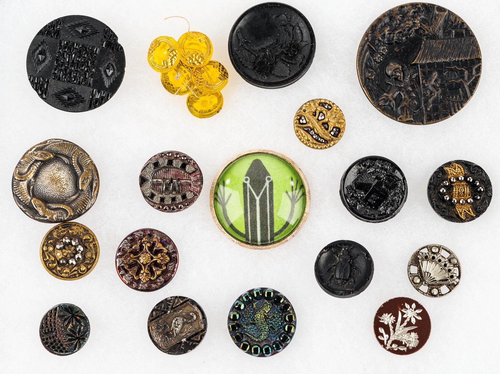 Grouping of Figural Buttons: Including various buttons with lizards, scarab button, etched buttons, and carved buttons.