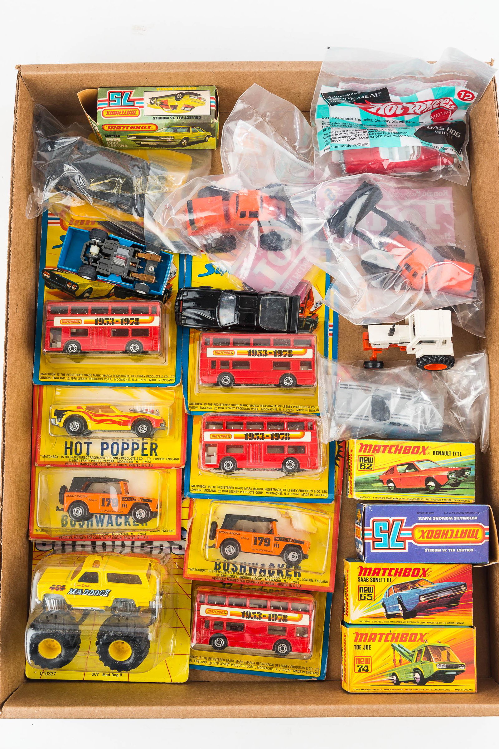 Vintage Matchbox Cars NIP: There are (12) Matchbox cars on hang card dating from 1970s to 1980; Tonka premiums in pack, others vehicles in pack, and a Richard Petty slot car, unmarked.