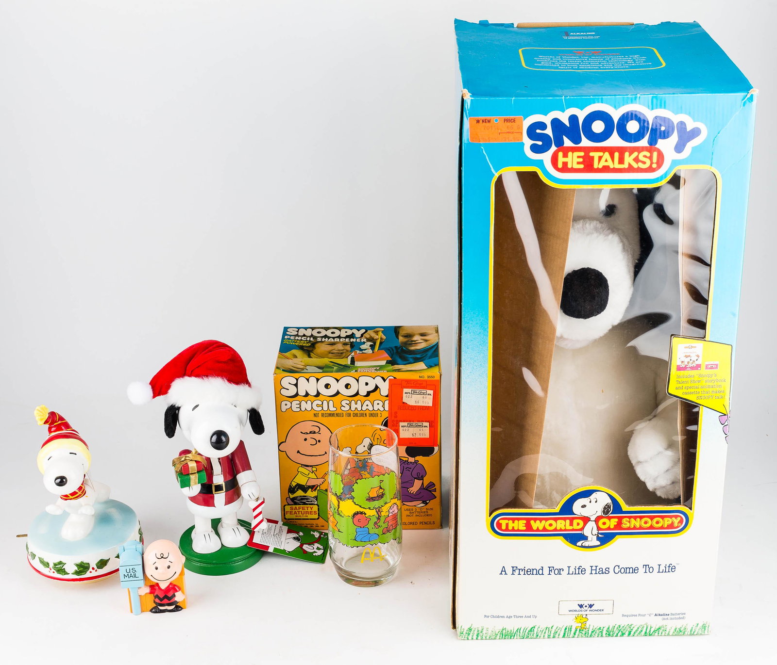 Talking Snoopy Doll and Related Items: Snoopy doll dated 1971 NIB, Snoopy pencil sharpener 1974, and loose, Snoopy-related figures.
