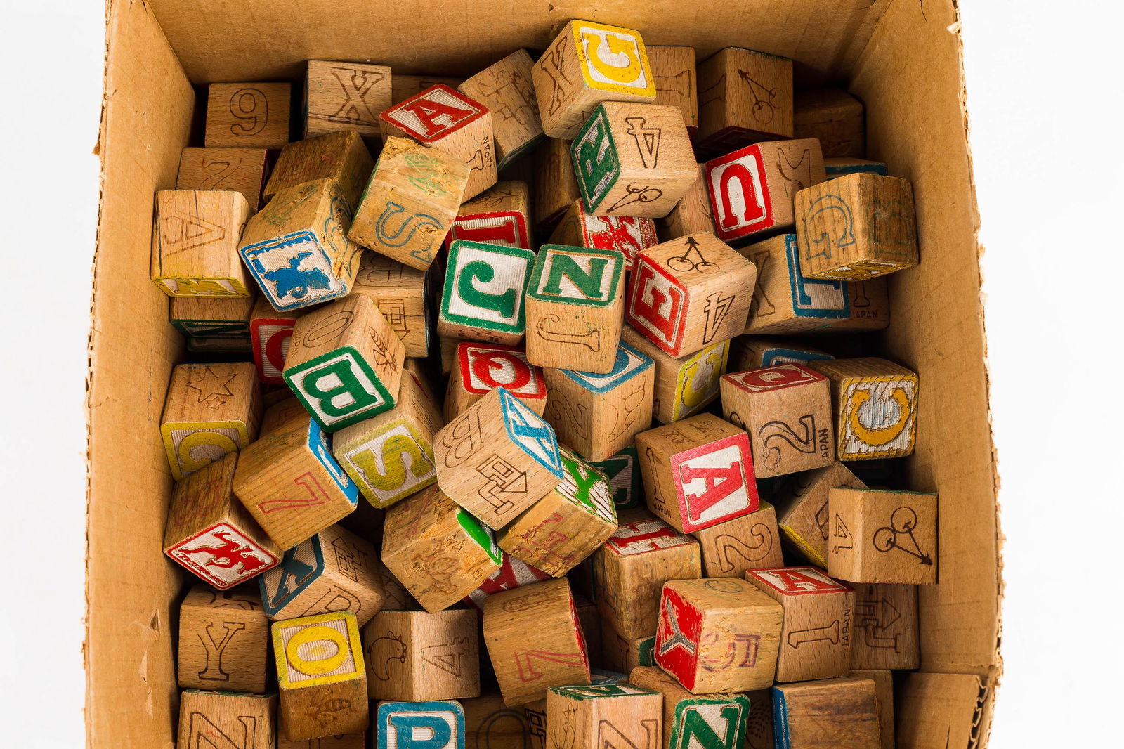 Collection of Wooden Toy Blocks: There is a ten-inch by twelve--inch nearly completely full of wooden toy blocks.