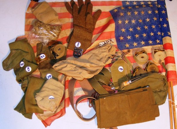 Two 48 Star Flags w/ military items: Two 48 star flags w/ misc. military items including gunners gloves, belts, socks, equipment. bag, etc
