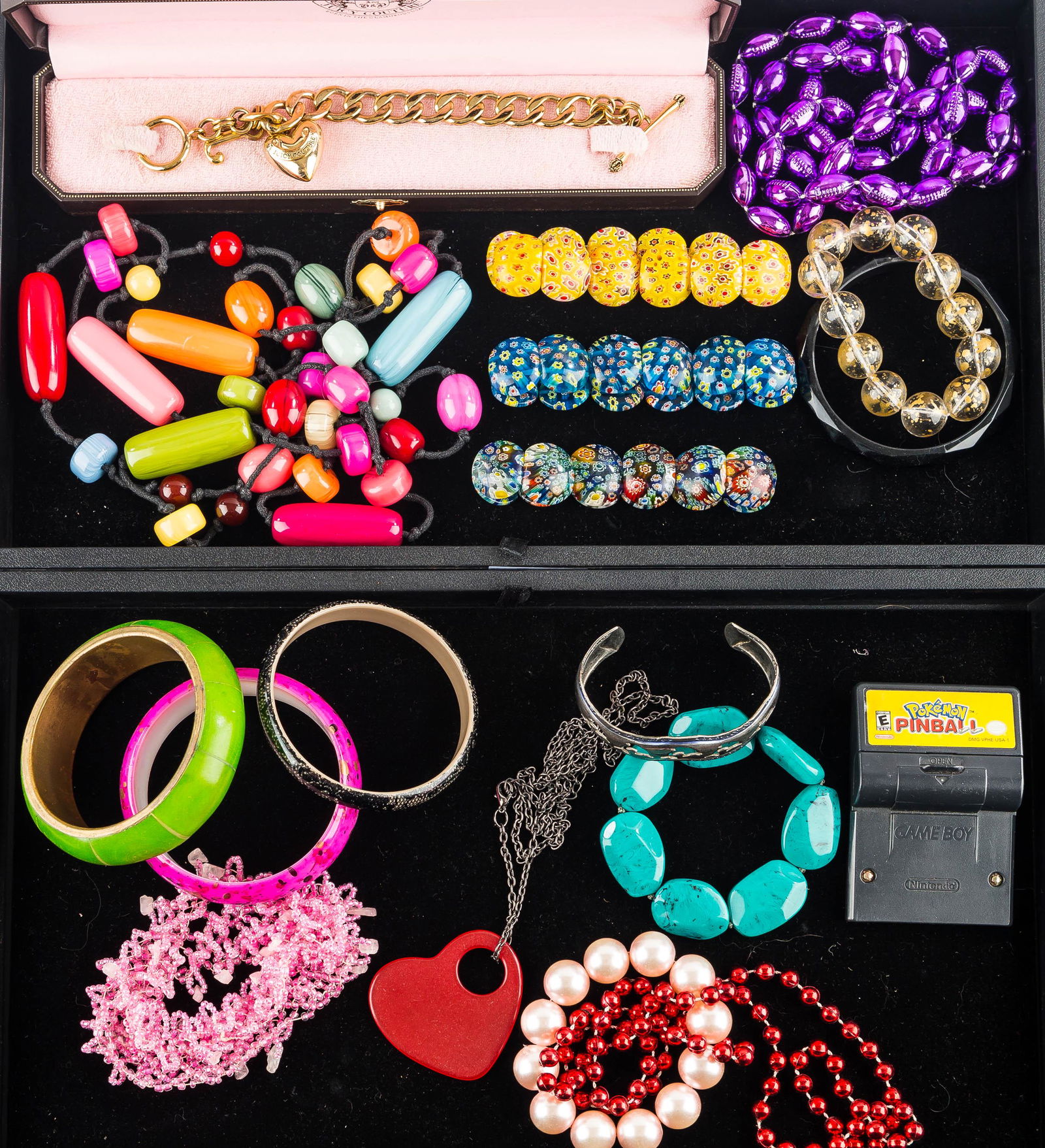 Colorful Costume Jewelry (2 Trays) & Juicy Couture: (3) millefiori type bangles, various other bangles, colorful beaded necklaces, and a Juicy Couture bracelet with heart pendant in original box.