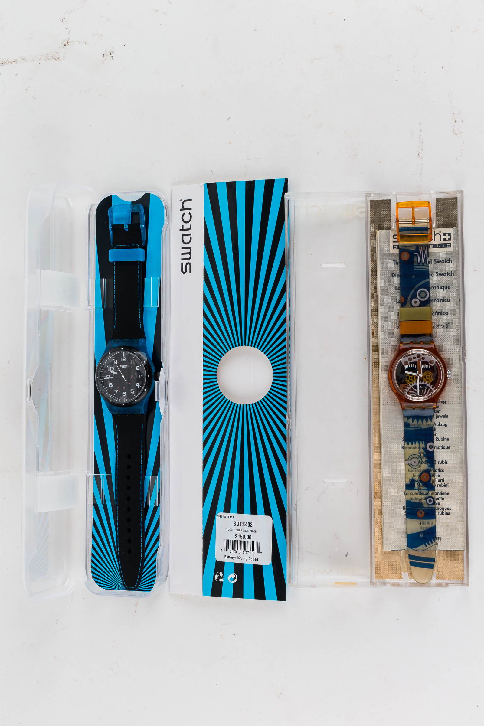 Swiss Swatch Watches (2) In Case NIP: a black Swatch with date and another with semi-skeletal movements.