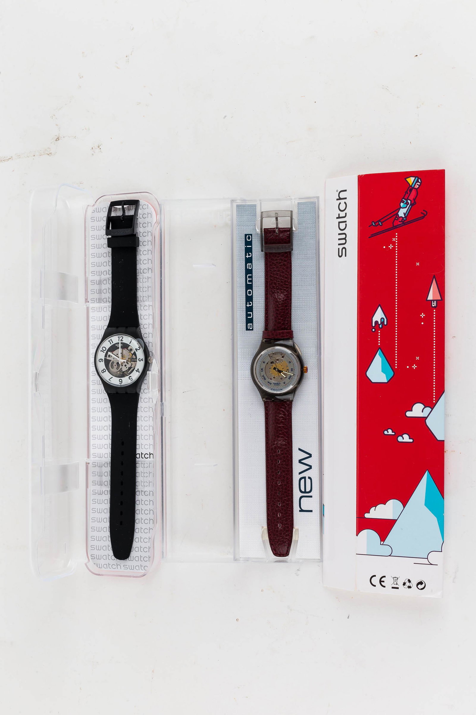 Skeletal Swiss Swatch Watches NIP (2): There are (2) skeletal Swatches, one with a brown leather band. Both are in original box.