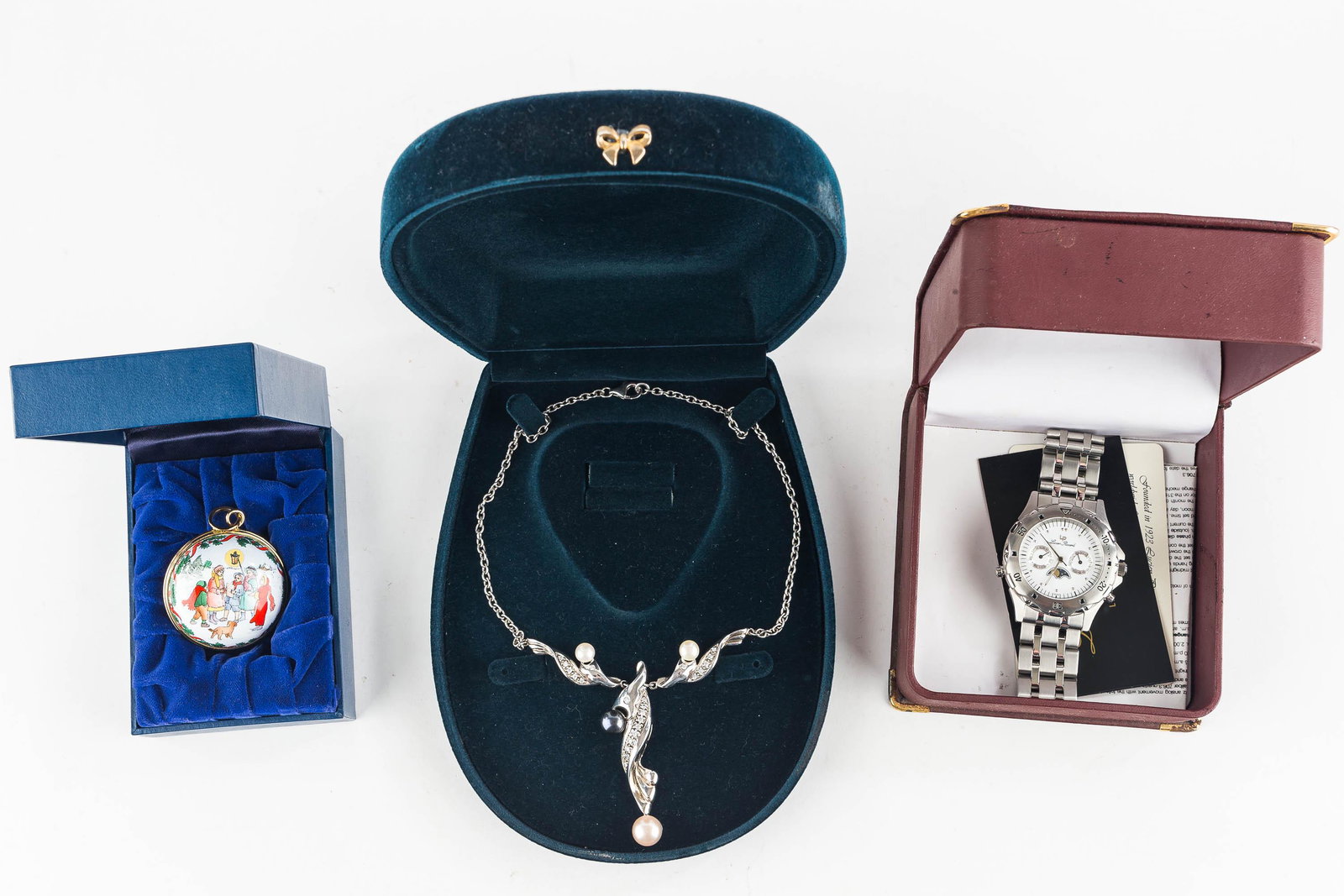 Lucien Piccard Watch & Jewelry Grouping: This Lucien Piccard stainless steel chromatic watch with sun and moon dial is marked 'Swiss' and numbered 26421WH; watch comes in the original box with paperwork; there is also a sterling silver neckl