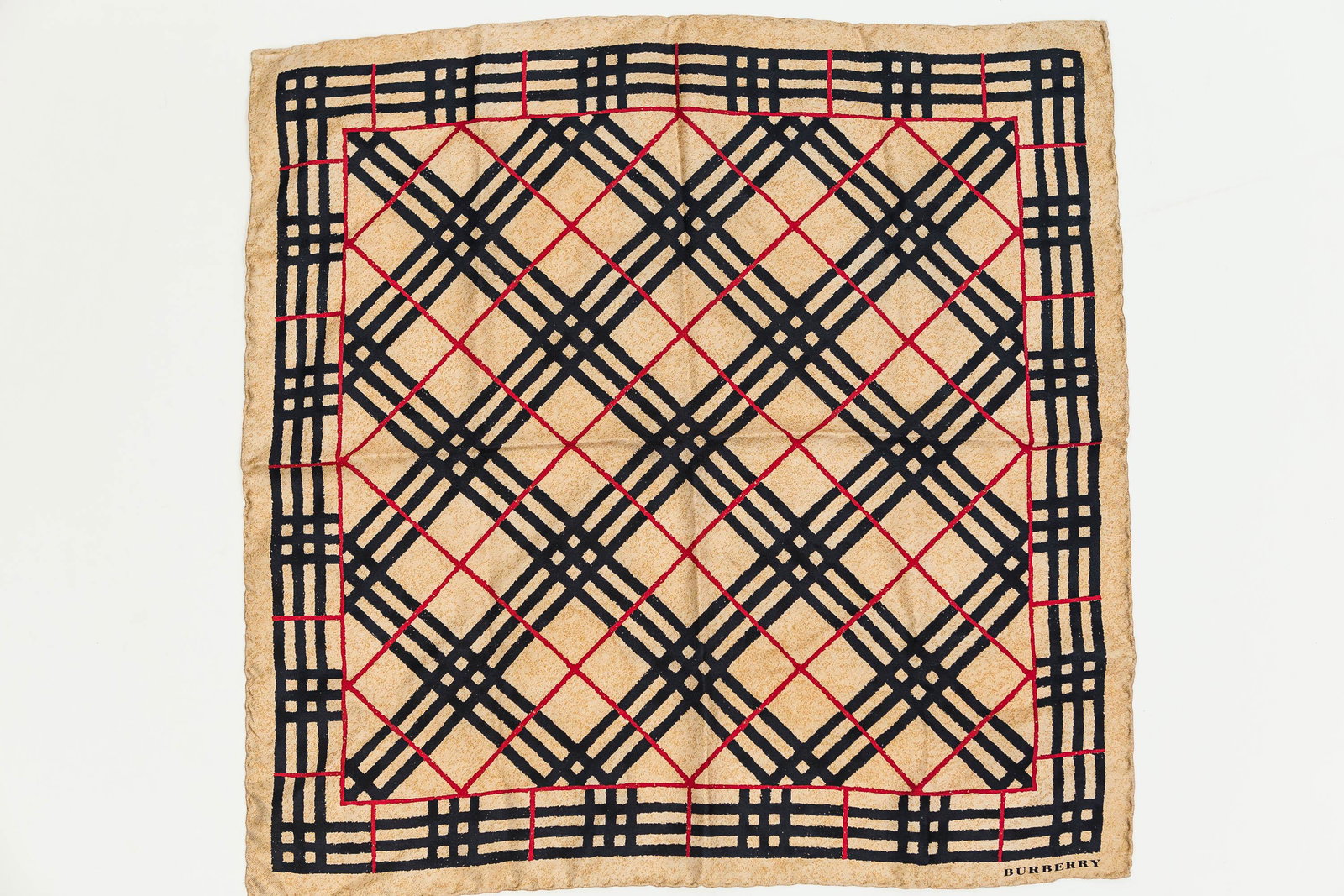 Burberry Designer Scarf: This Burberry London silk scarf features the signature Nova check and red detailing.