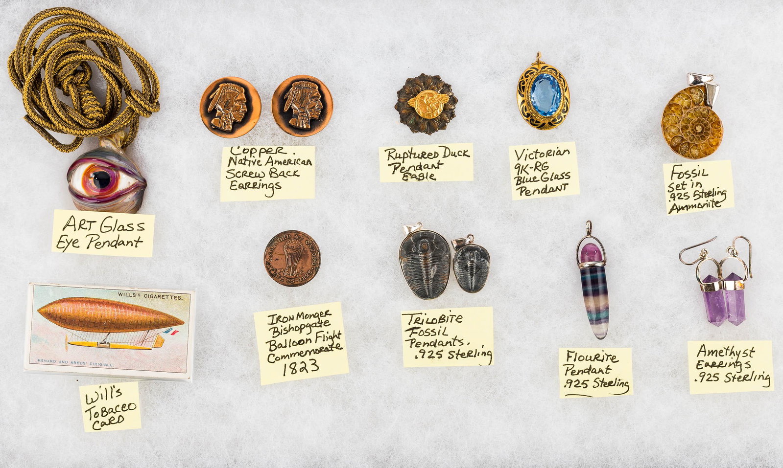 Sterling Fossil & Mineral Jewelry: There are three trilobites perched on sterling silver mounts, a fossilized shell with sterling mount, amethyst earrings with sterling mounts, a Victorian 9k rolled gold pendant with blue glass stone, 