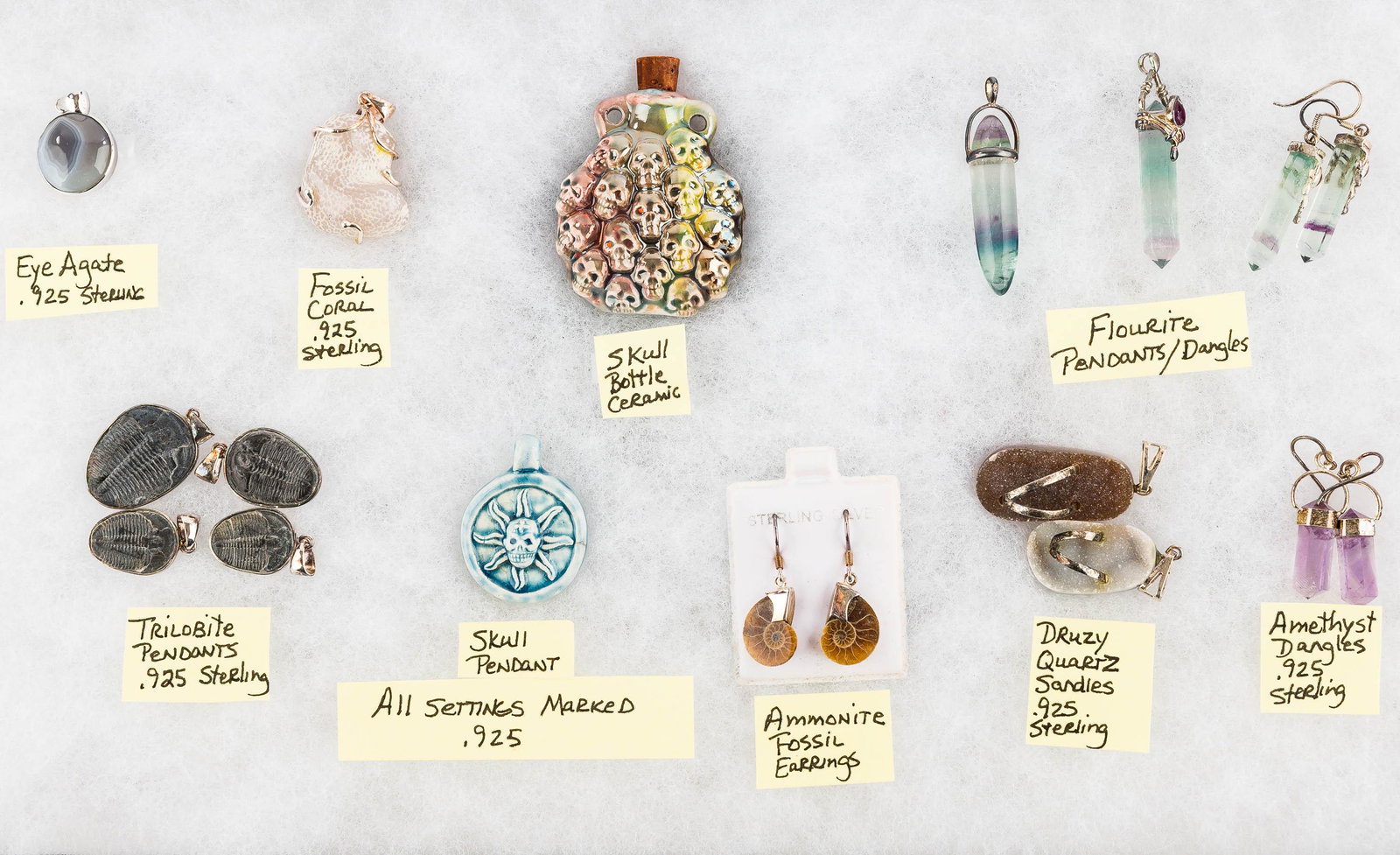 Fossil & Mineral Sterling Silver Mounted Jewelry: This lot features fluorite pendants with silver mounts, amethyst and sterling earrings, druzy quartz sandal pendants with sterling mounts, trilobite and shell fossils with sterling mounts, a ceramic s