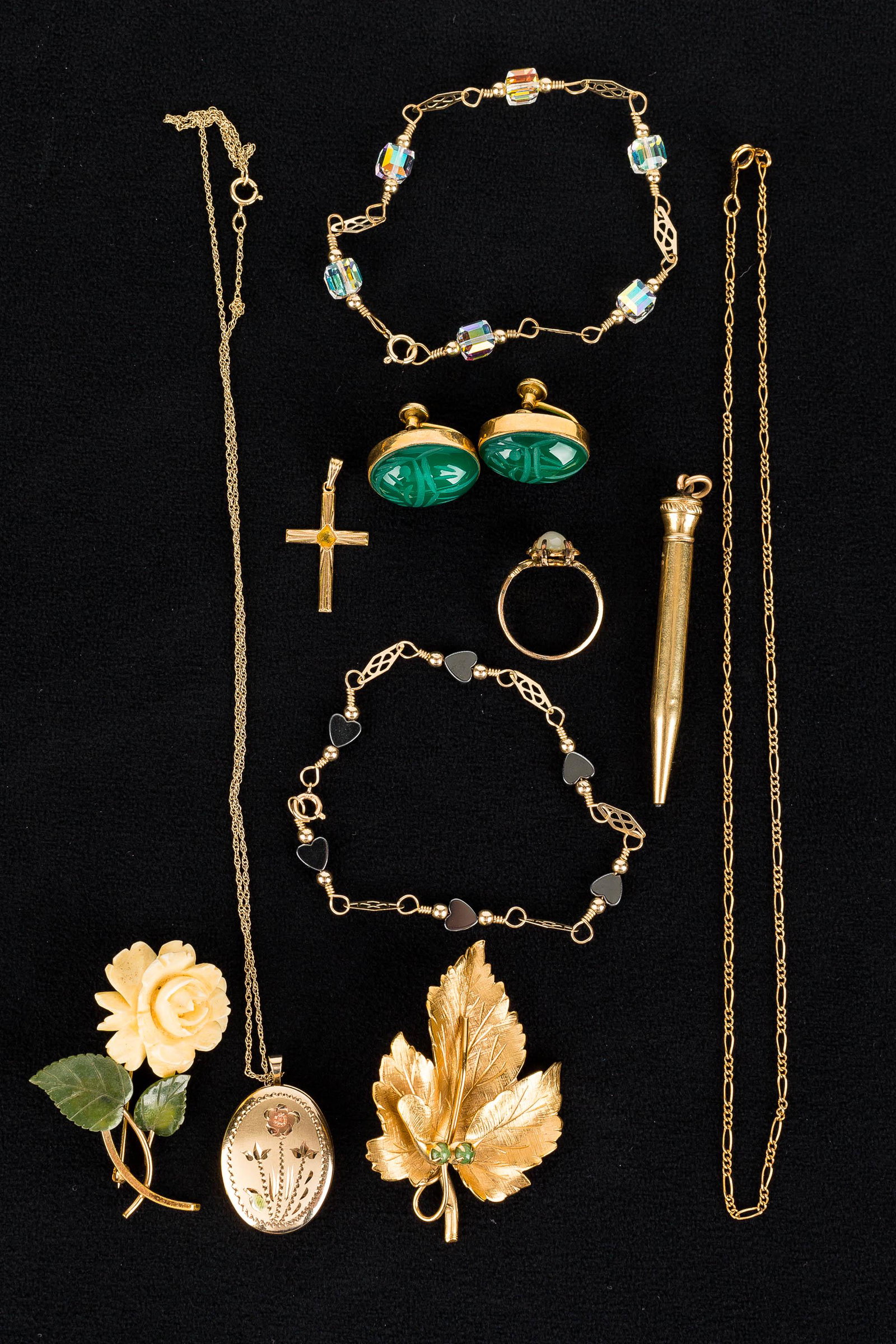 Gold-Fill Jewelry Grouping: Grouping includes a pair of green scarab screw back earrings, a Wells gold-fill leaf pin, a floral locket on chain, a sweater pen, and other gold-fill jewelry.