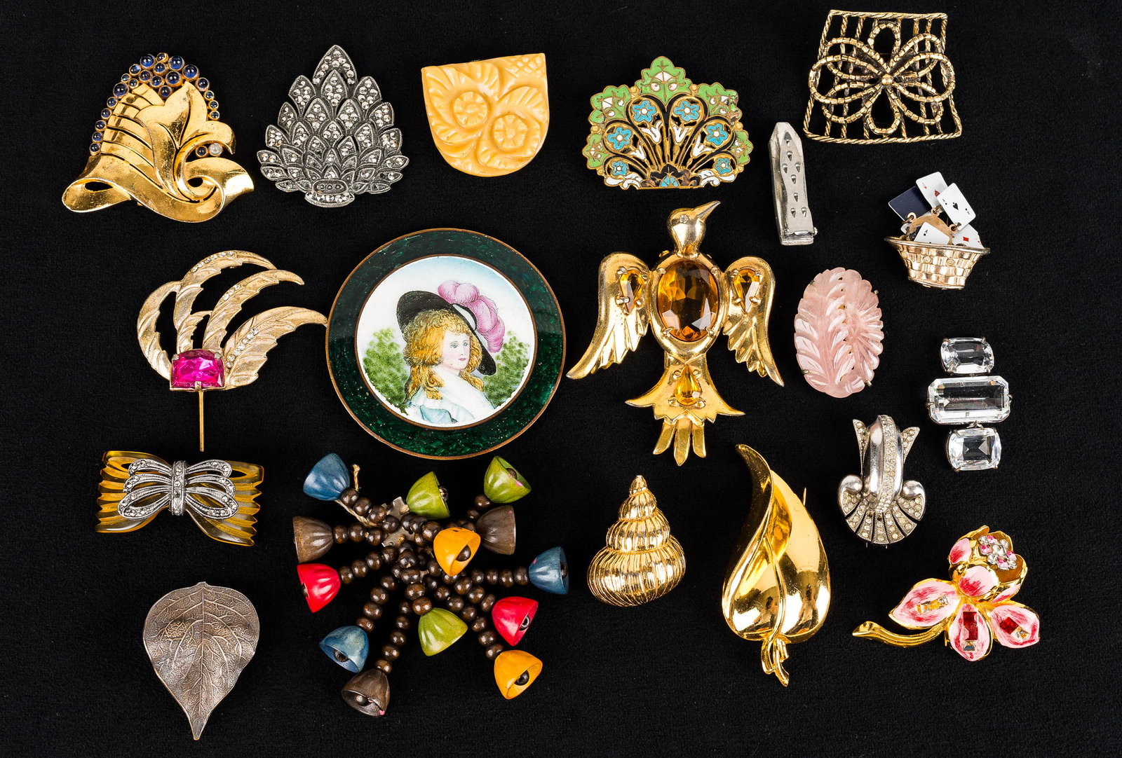 Victorian & Other Fur Clips and Pins: Collection includes a Victorian floral fur clip testing positive for pink jadeite, large gold tone eagle fur clip, marcasite inlay fur clip, leaf fur clip marked AF Paris, a reverse painted medallion 