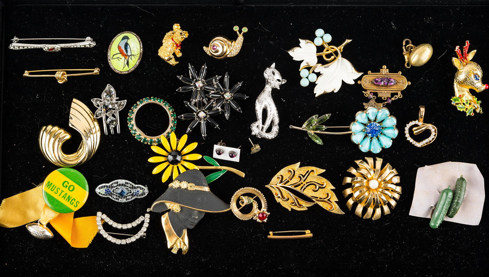 Figural & Other Brooches and Pins: There is an Artco Rudolph the Reindeer pin, a Monet silver tone cat brooch, a snail pin, a teddy bear pin, a flapper head pin with obscure mark, an enameled bird pin, and others.