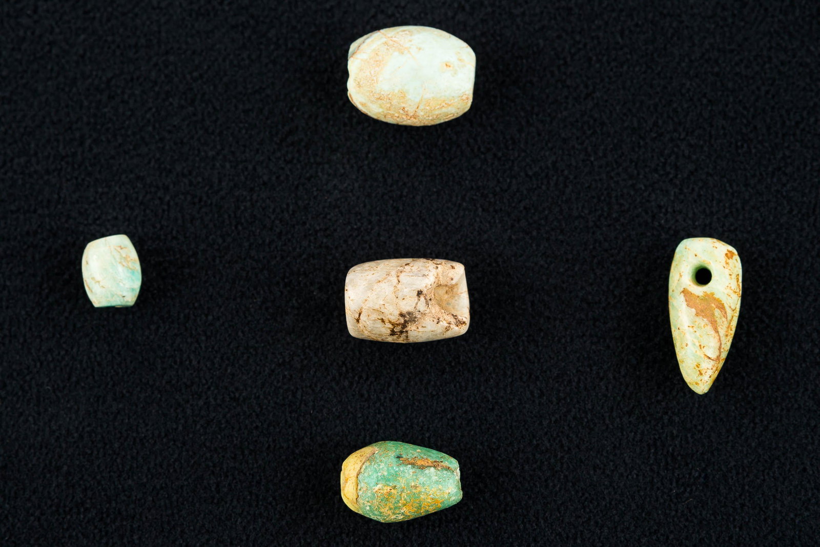 Semi-Precious Neolithic Saharan Beads & Pendant: This collection include (4) amazonite biconical drilled beads and one pendant. The largest measures about 3.75" L.
