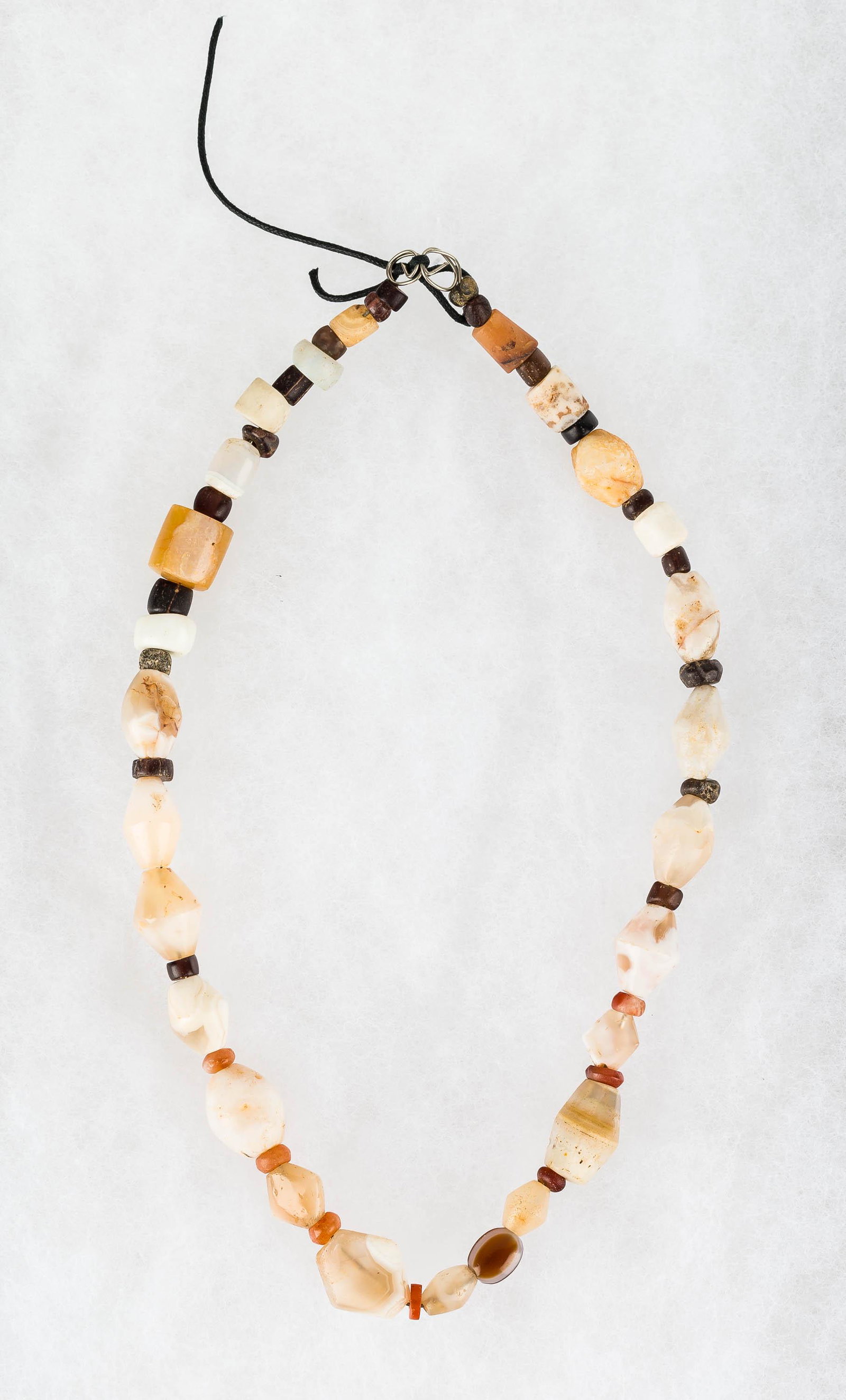 Neolithic Biconical Drilled Agate Necklace: This necklace consists of various agate, including eye agates and others, and carnelian stones. It has been restrung, and measures approx. 17"L.