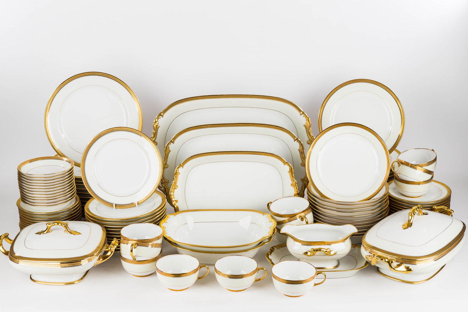 Vignaud Limoges Dinnerware Service for 12: This set of Limoges china dinnerware includes (12) 9.5" dinner plates, (12) 8.5" salad plates, (12) cups and saucers, (12) soup bowls, (12) dessert plates, (12) bread and butter plates, (1) 16.5" meat