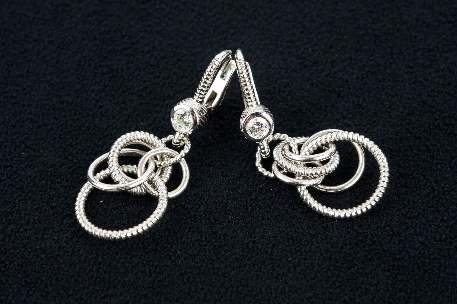 Judith Ripka Designer Sterling Silver Earrings: These sterling silver dangle drop pierced earrings with C.L. accent are signed Judith Ripka.