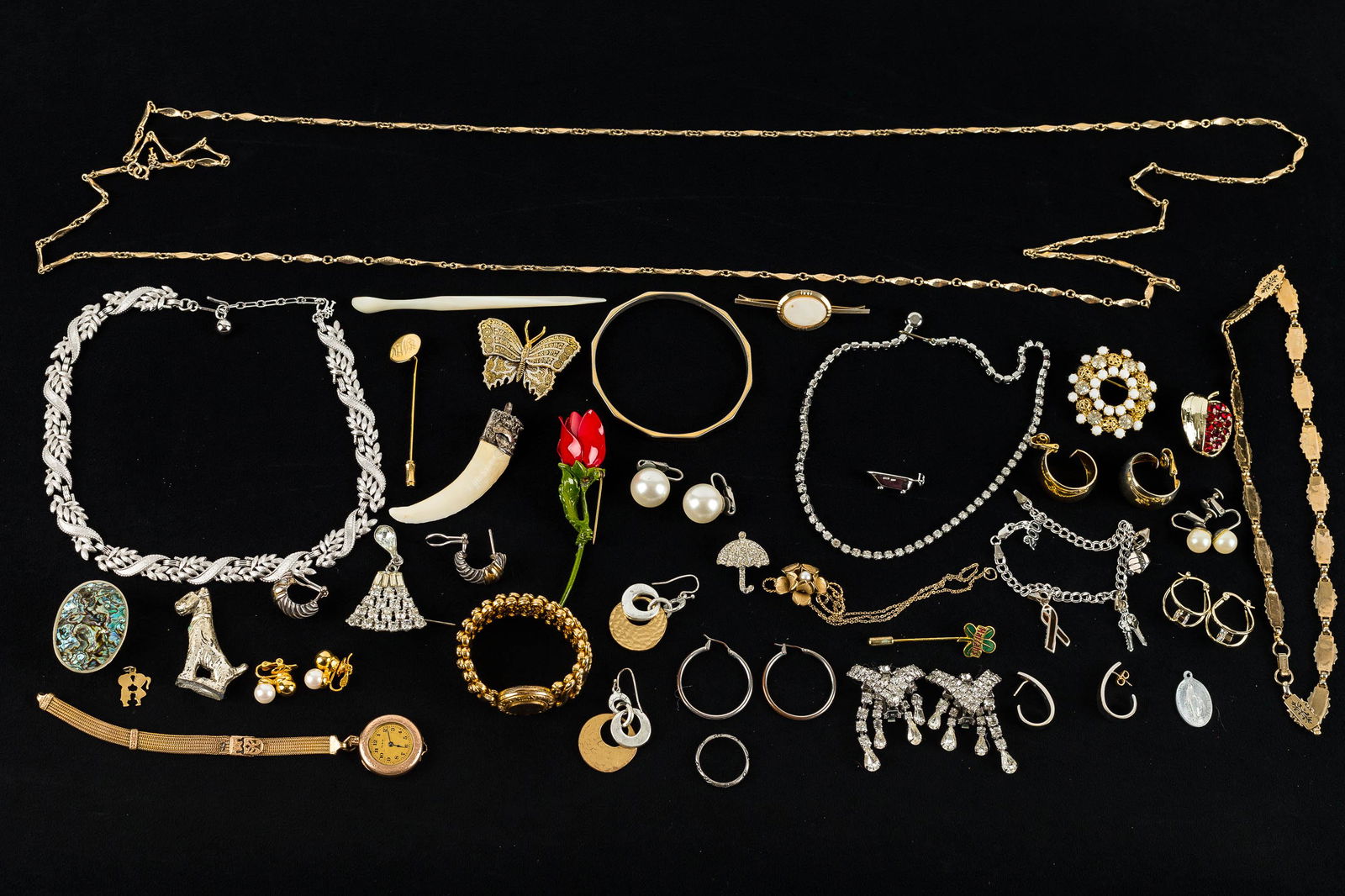 Mixed Costume Jewelry Collection: This collection features a gold tone Marino necklace measuring approx. 17"L, a silver tone Trifari leaf necklace measuring approx. 16"L, a gold-fill floral pin with central pearl (chain is tangled), a