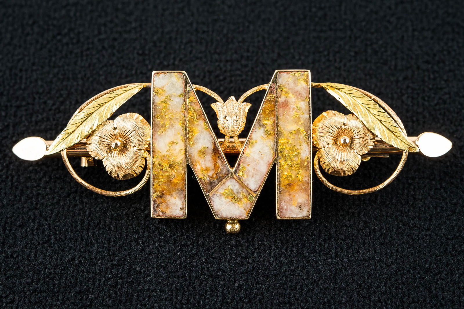 CA Gold Rush Quartz & Gold Ore in 14k Monogram Pin: This pin is marked 14k and has a hinged C-clasp, rose gold flowers with yellow gold leaves, and a gold rush era polished quartz and 24k gold ore mineral in the form of an "M". (The mineral has some li