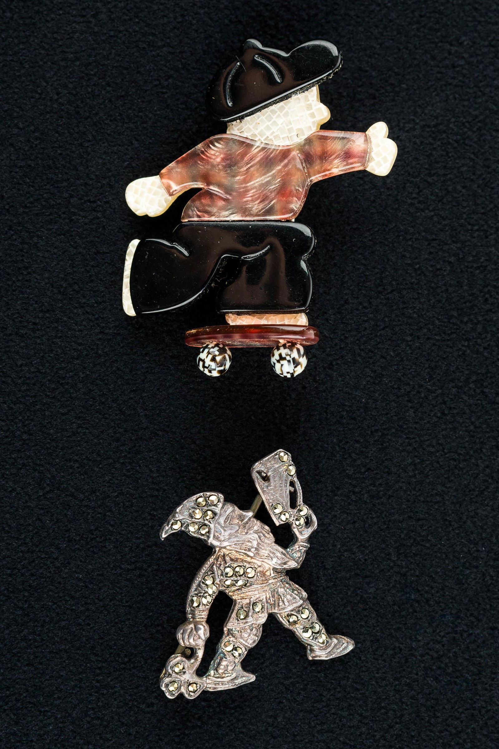 Lea Stein Vintage & Sterling Silver Pins: This Lea Stein Paris skateboard figure pin measures approx. 1.75" and is paired with a sterling silver marcasite pin (some stones darkened) depicting a gnome carrying a heart and a clover.